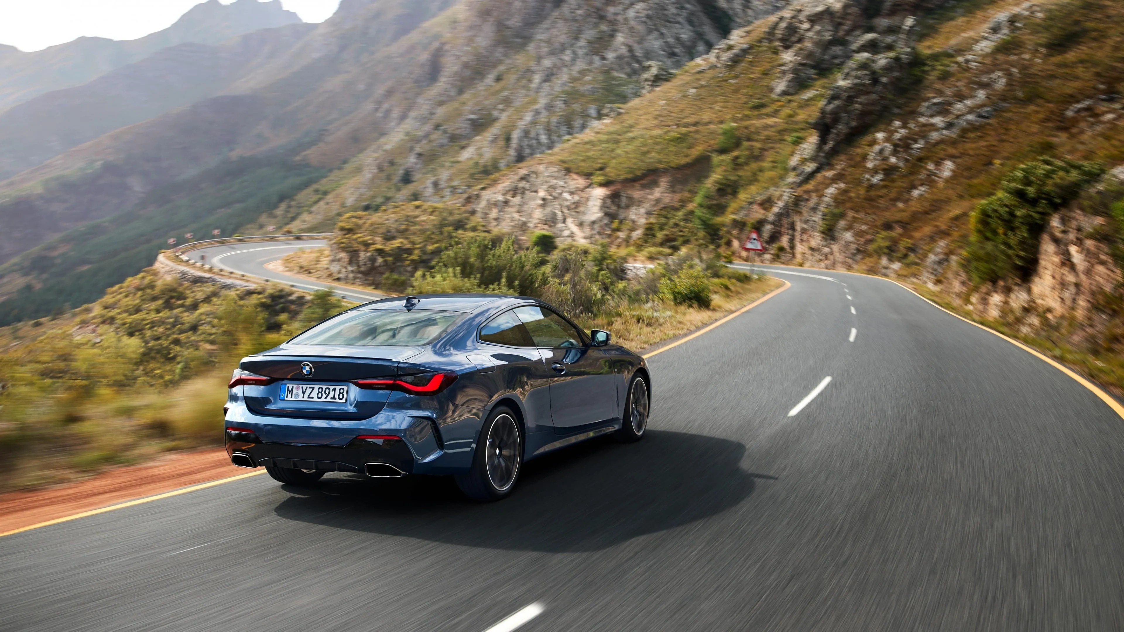 Bmw Coupe Driving on Mountain Road Under Clear Skies
