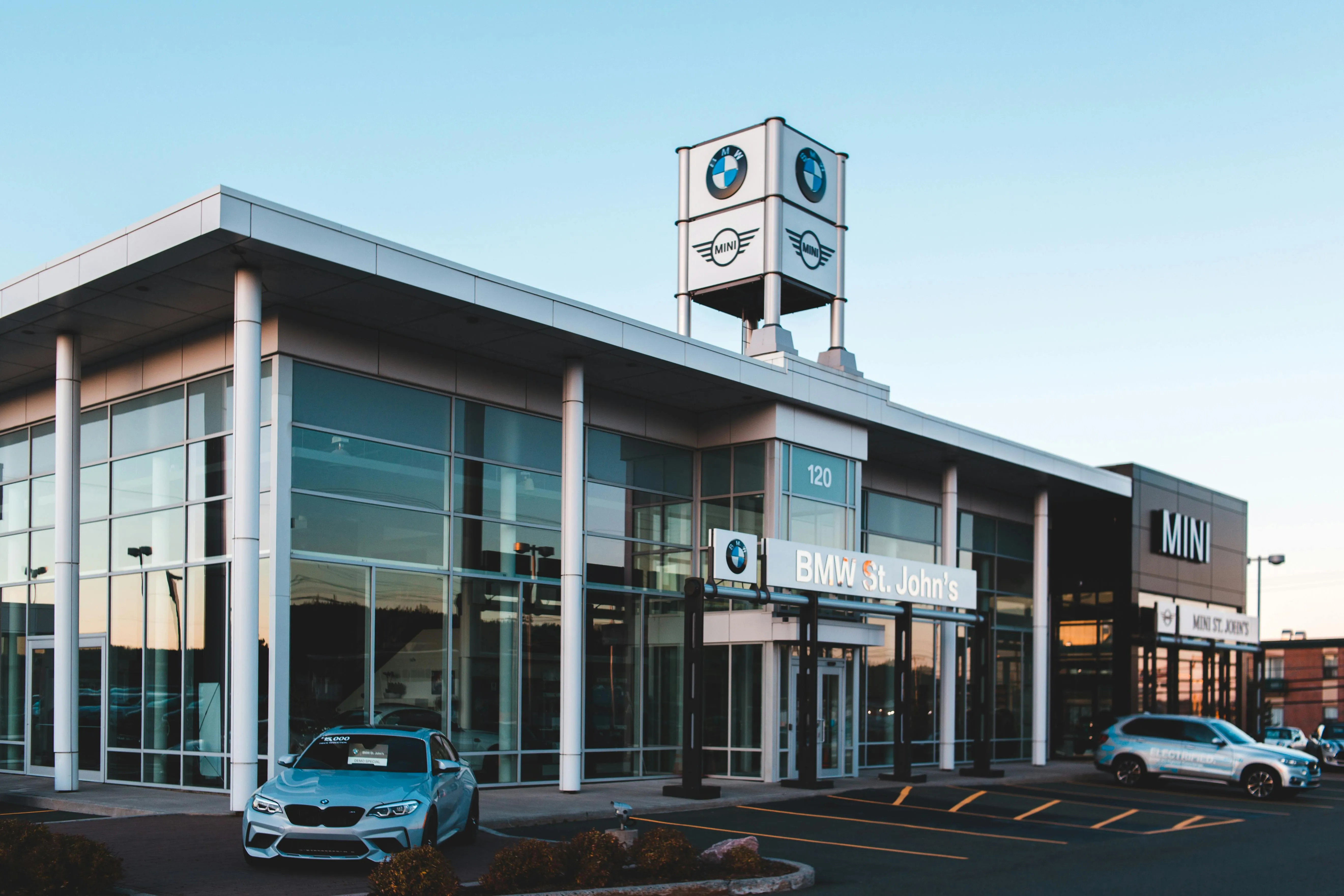 Bmw Dealership Building with Multiple Cars in Parking Lot