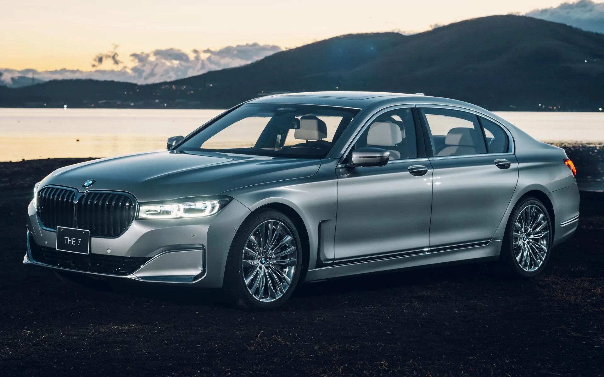 Bmw Driving Along Coastline During Sunrise Or Sunset