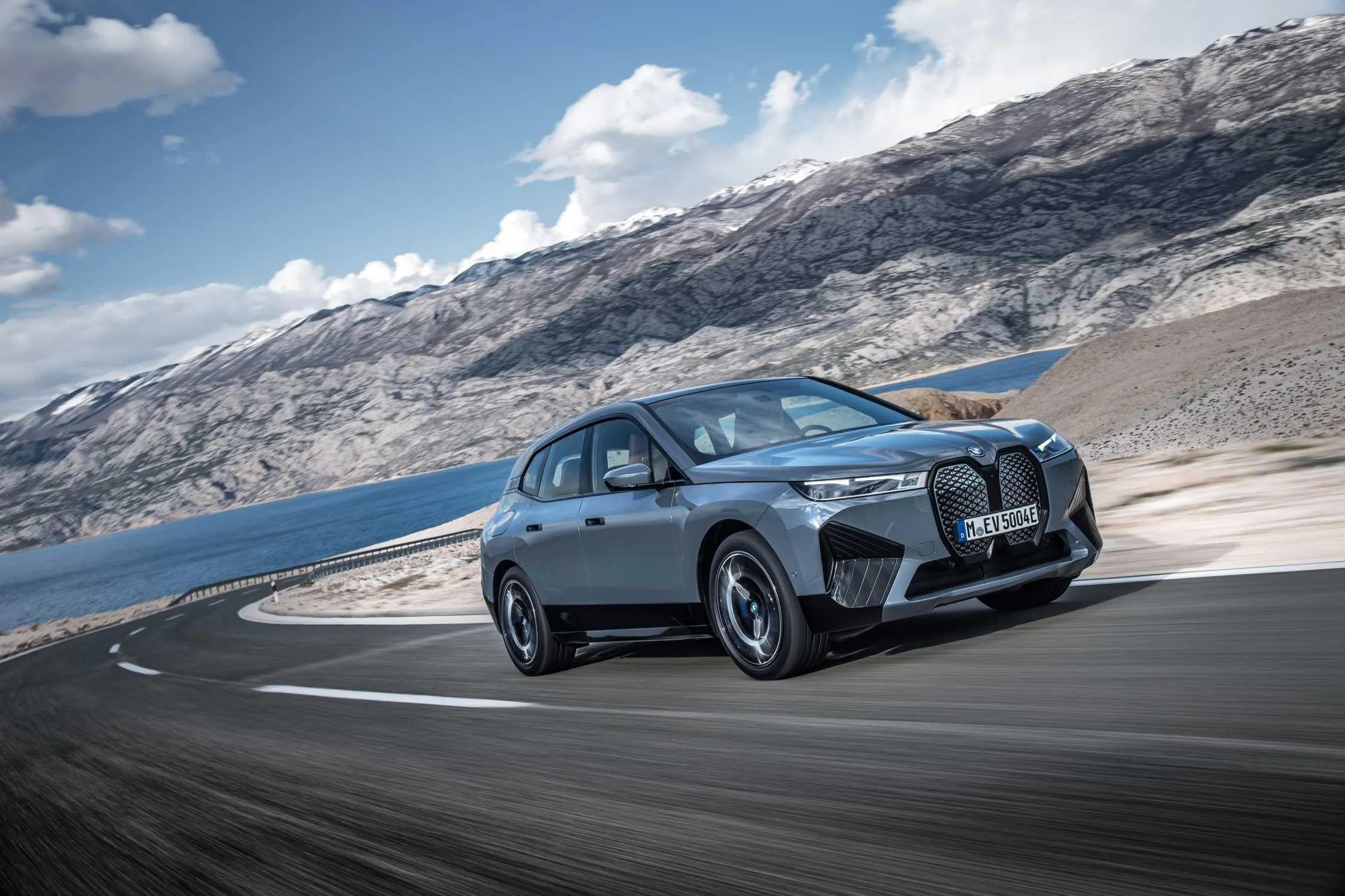 Bmw Driving Fast Along Snowy Mountain Road with Sky Views