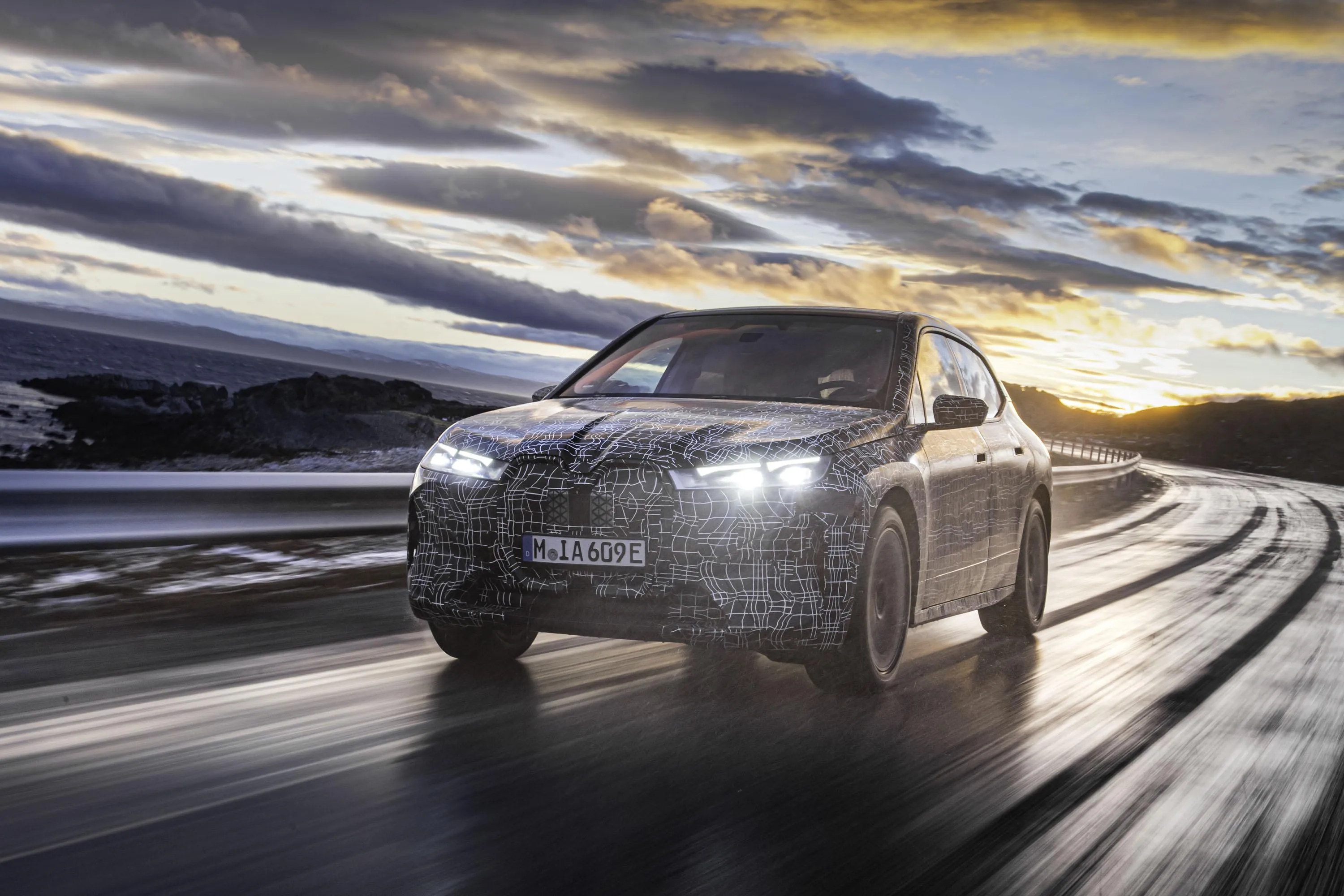 Bmw Driving Fast on a Wet Road with Dramatic Sky Wallpaper