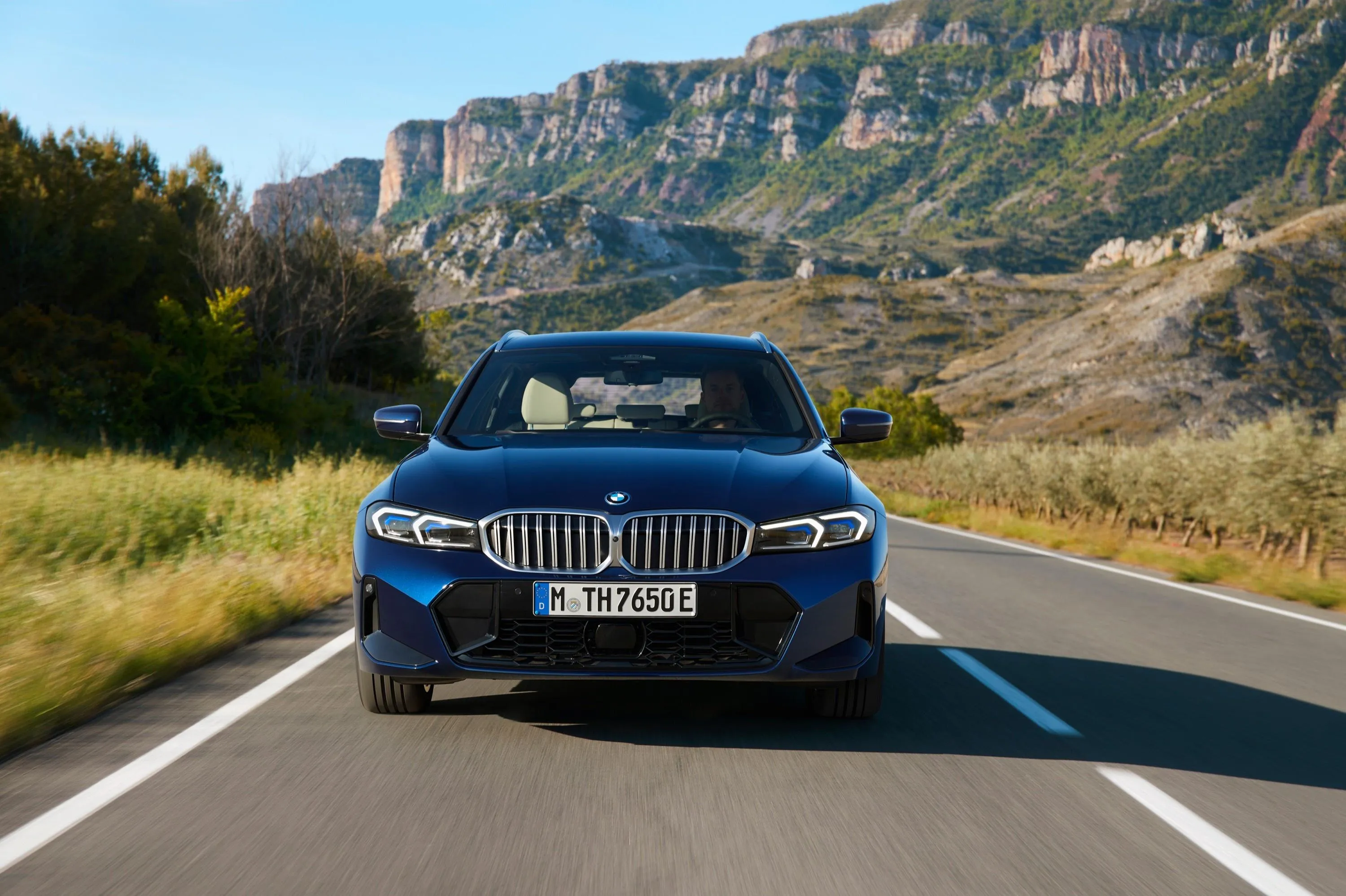 Bmw Driving on Road Through Scenic Green Mountain Area