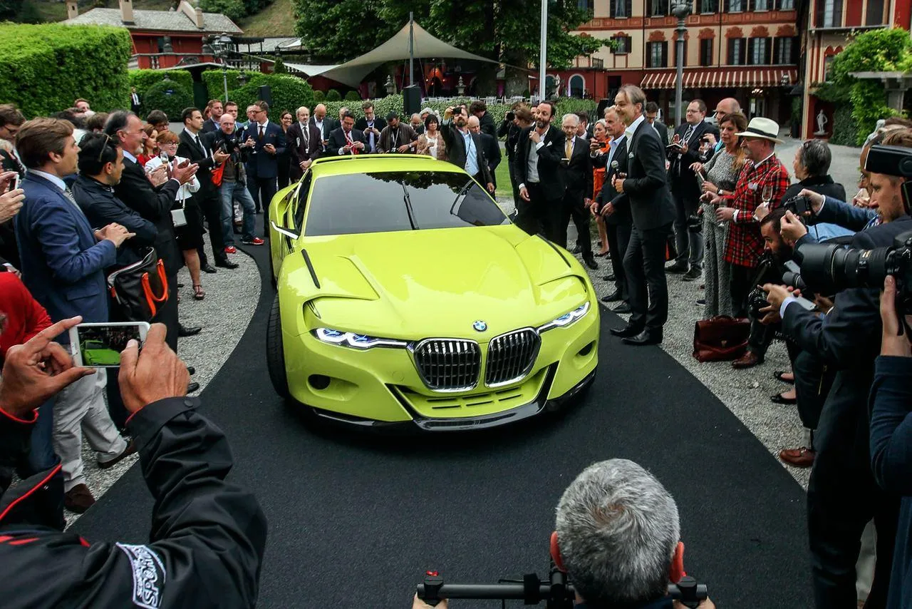 Bmw Electric Car in Bold Yellow Driving Through Crowd