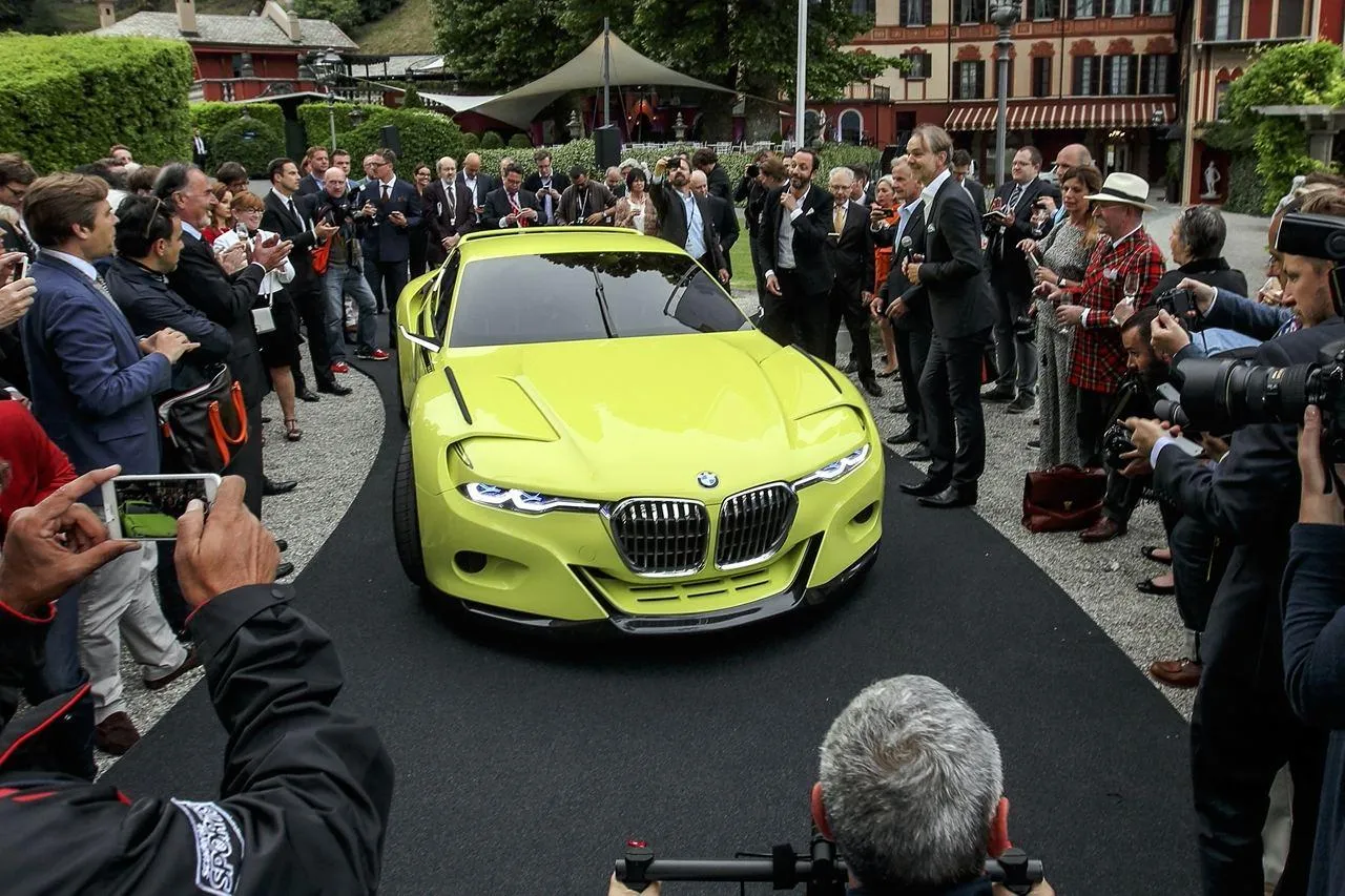 Bmw Green Sports Car Surrounded By Crowds Wallpaper