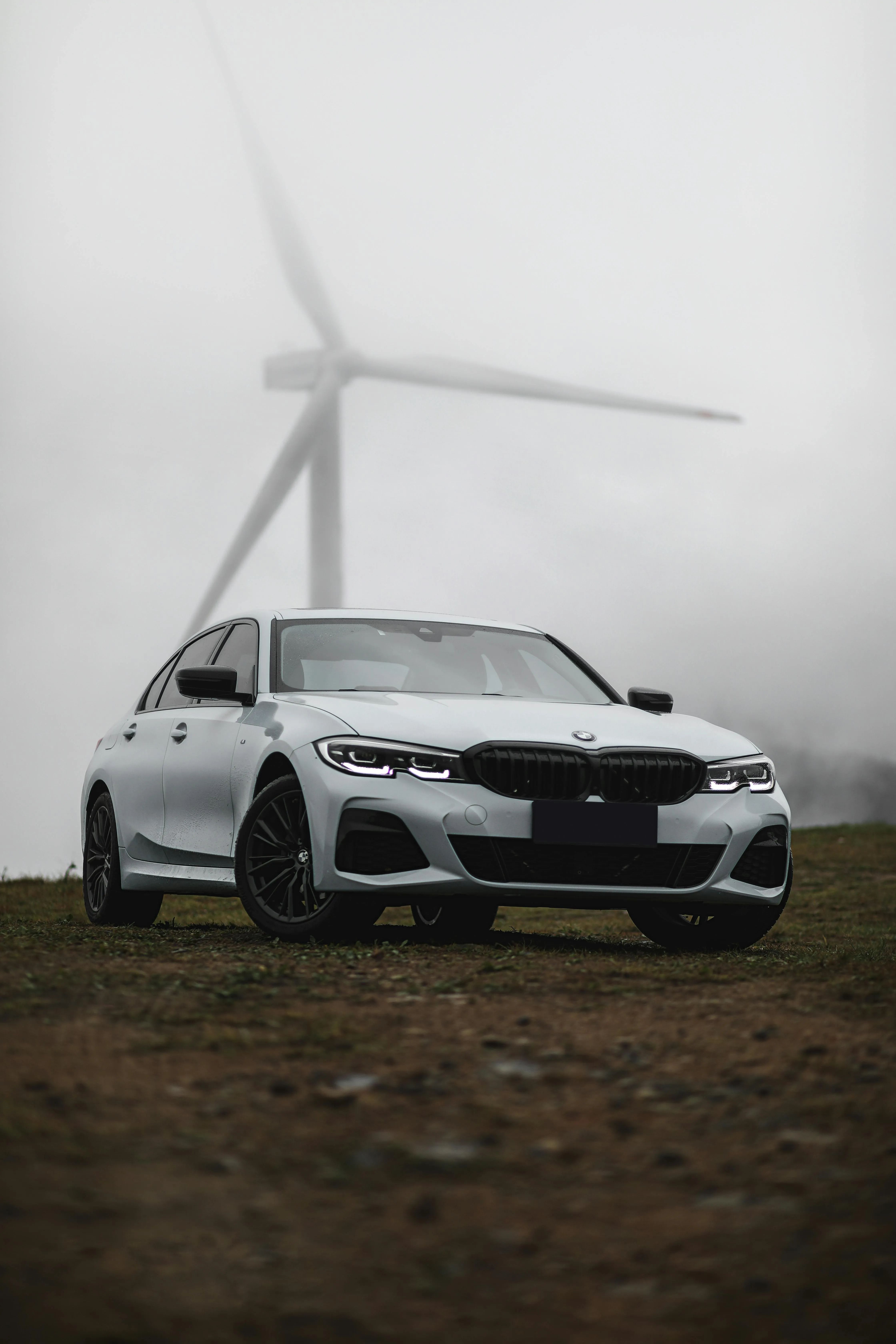 Bmw in Front of Wind Turbine on Foggy Rural Landscape