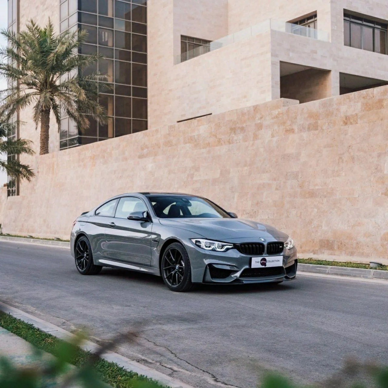 Bmw in Motion Driving Down a Road in Urban Setting