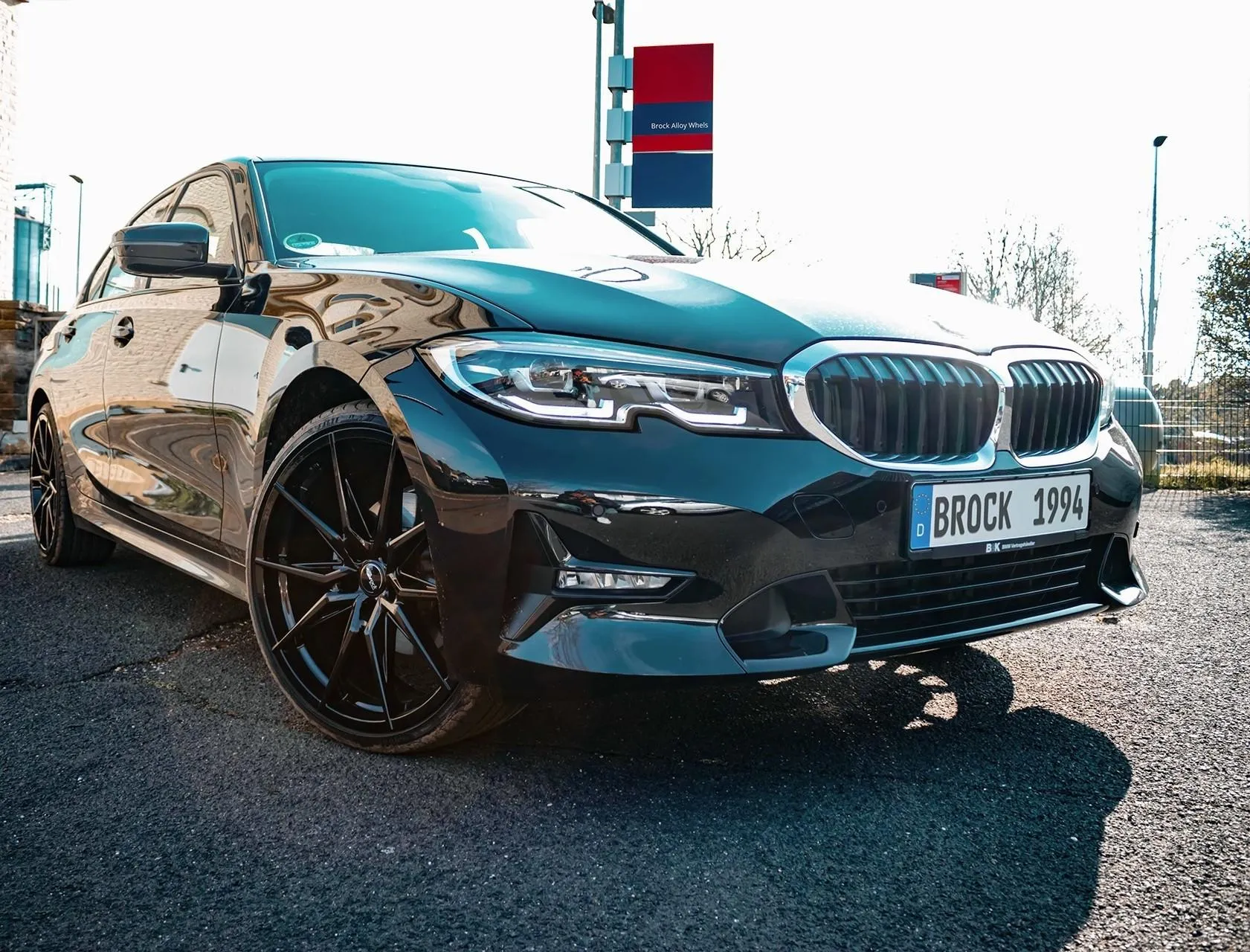 Bmw in Urban Parking Area with Sunlight Reflection Image