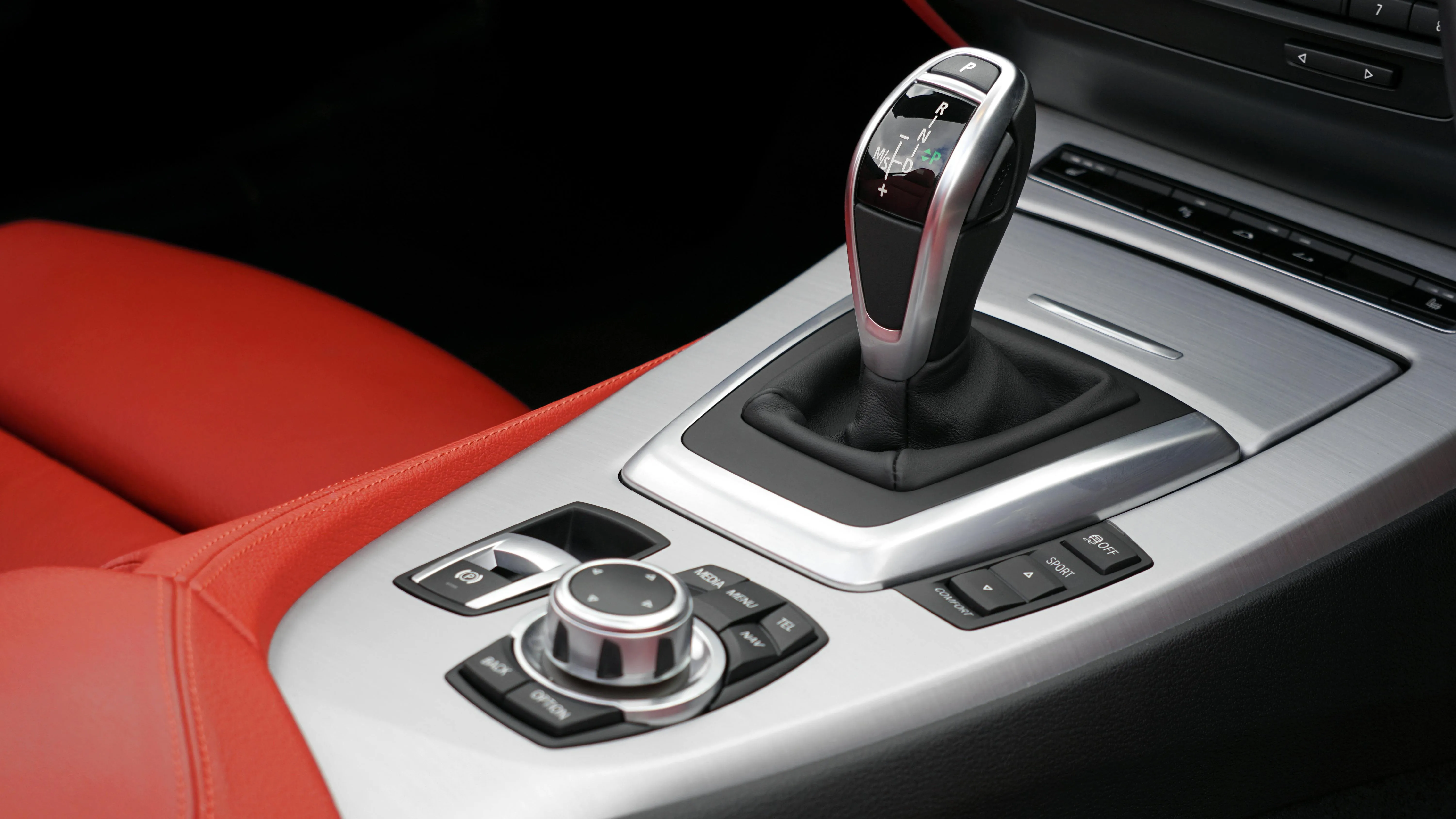 Bmw Interior Showing Gear Shift on Red and Black Console
