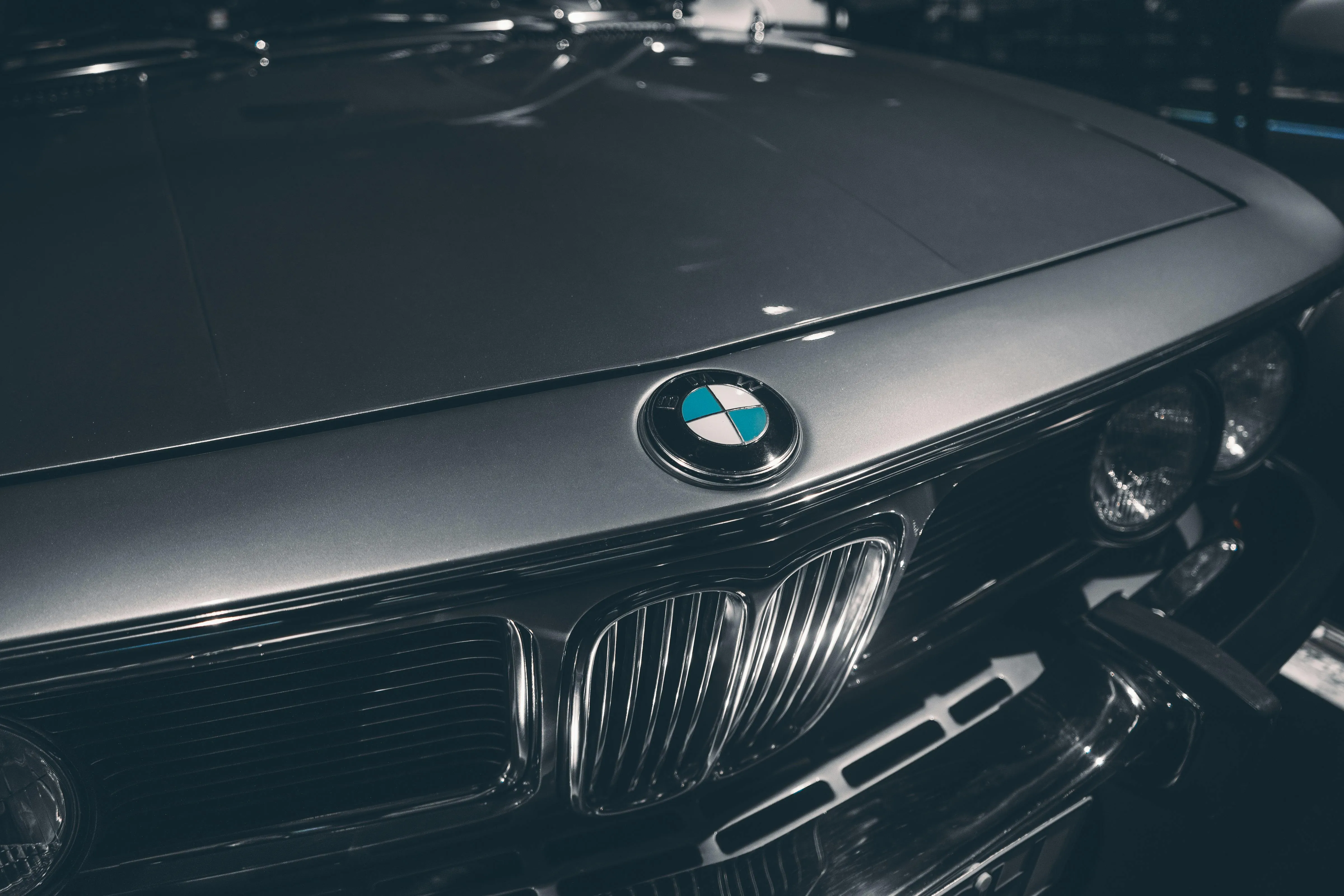 Bmw Logo and Carbon Fiber Hood with Sharp Reflections Image
