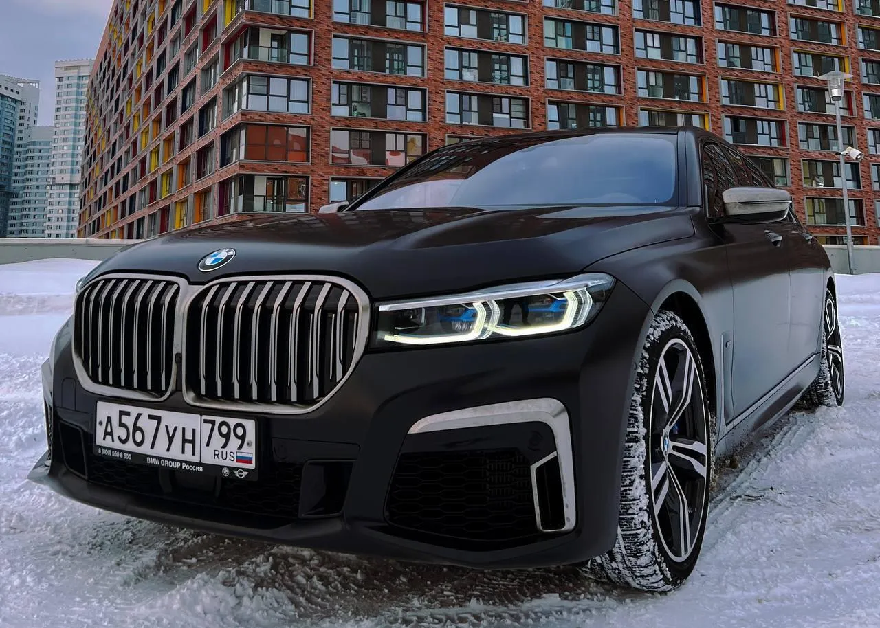 Bmw Luxury Car Parked in Front of Urban Apartments