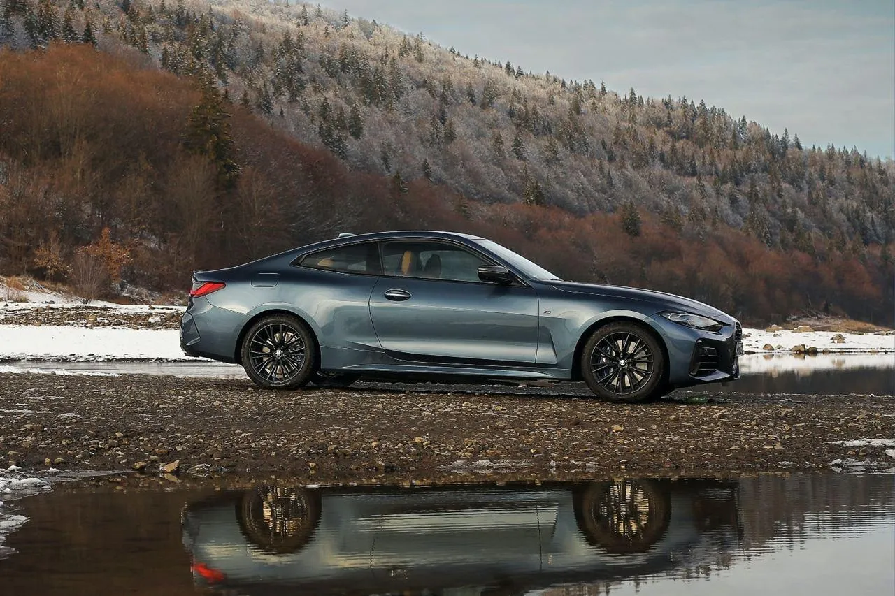 Bmw Luxury Coupe Reflected on Calm Water Surface Image