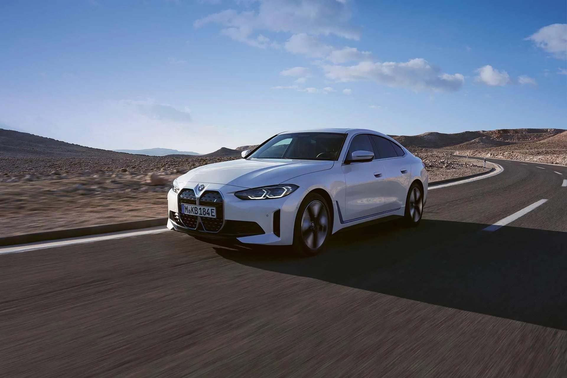 Bmw Luxury Sedan Driving on a Smooth Desert Road Image