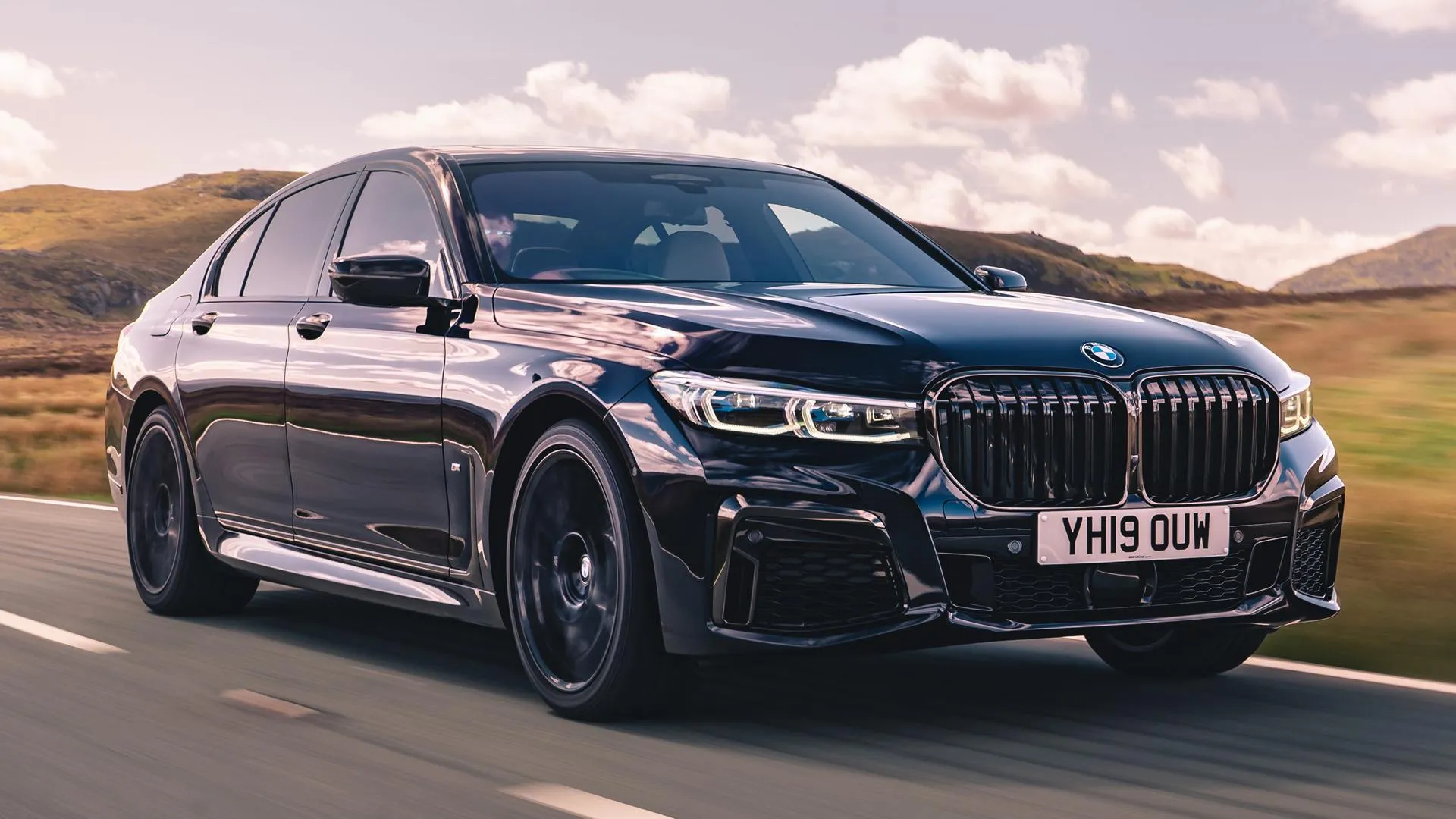 Bmw Luxury Sedan Driving on an Open Highway During Sunset