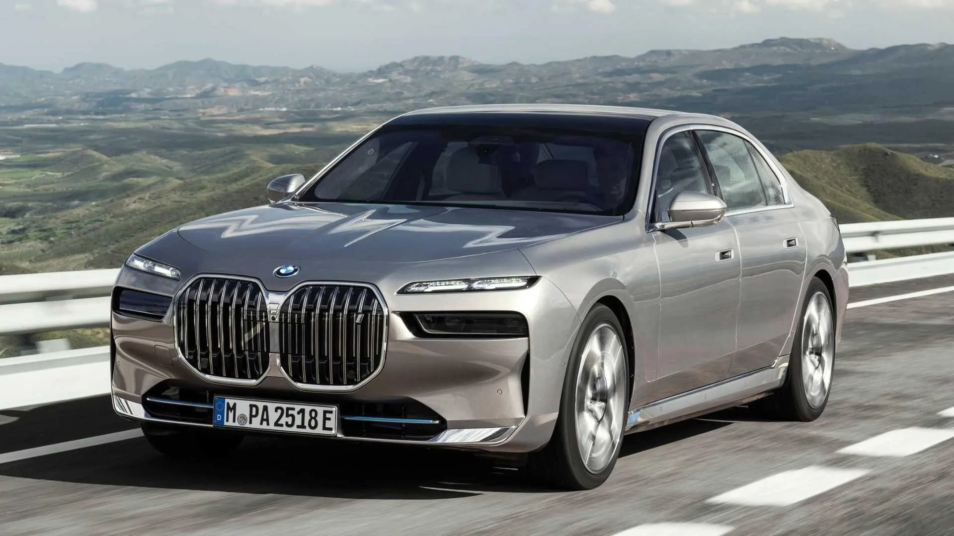 Bmw Luxury Sedan Driving Through Scenic Mountain Road