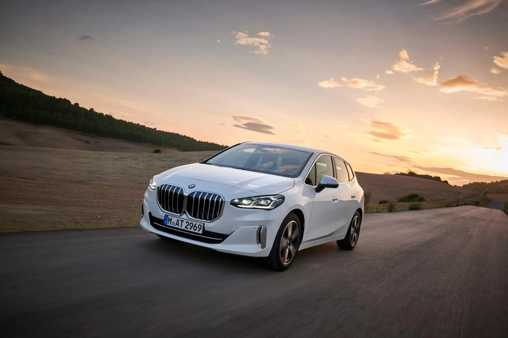 Bmw Luxury Sedan Driving Through Scenic Open Road Image