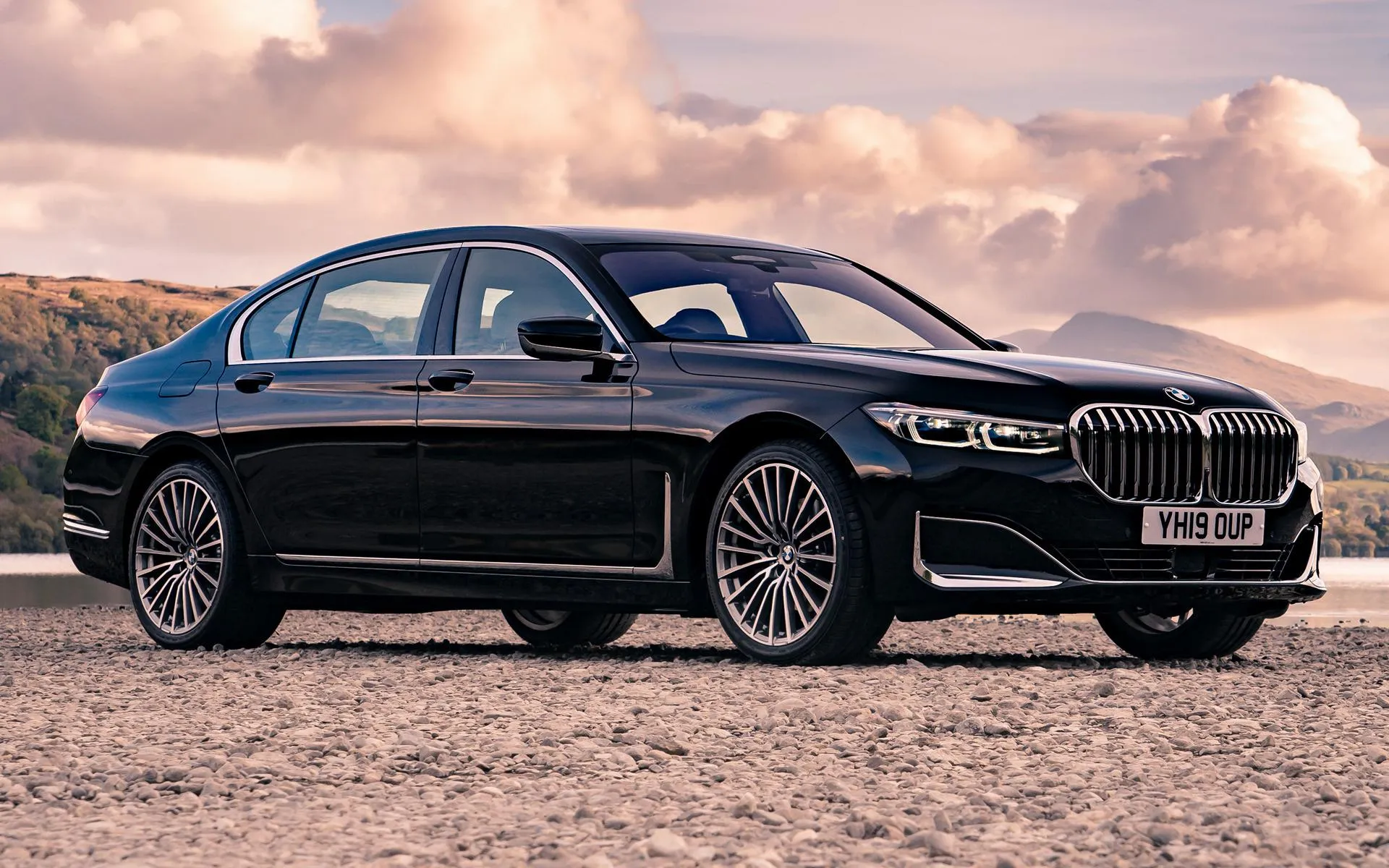 Bmw Luxury Sedan with Sunset Sky and Scenic View Wallpaper
