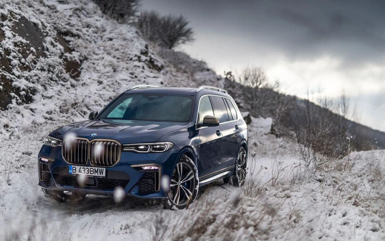 Bmw Luxury Suv Driving Through Snowy Landscape Wallpaper