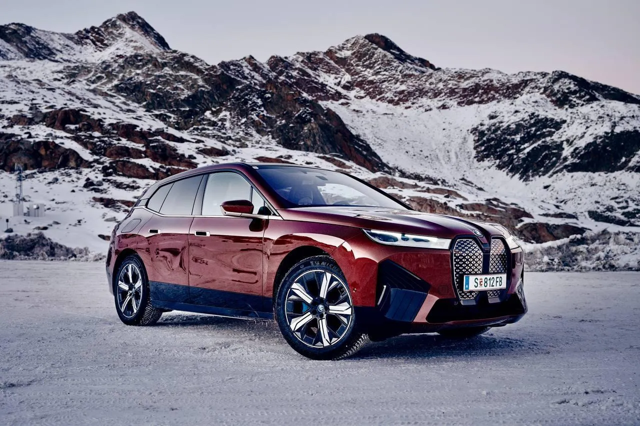 Bmw Luxury Suv Driving Through Snowy Mountain Terrain