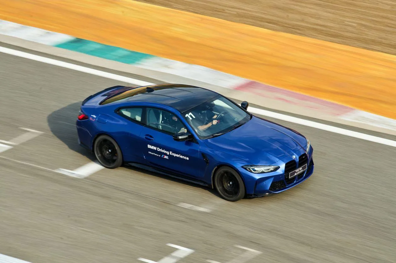 Bmw M Series Sedan Driving Fast on Race Track Turn Wallpaper