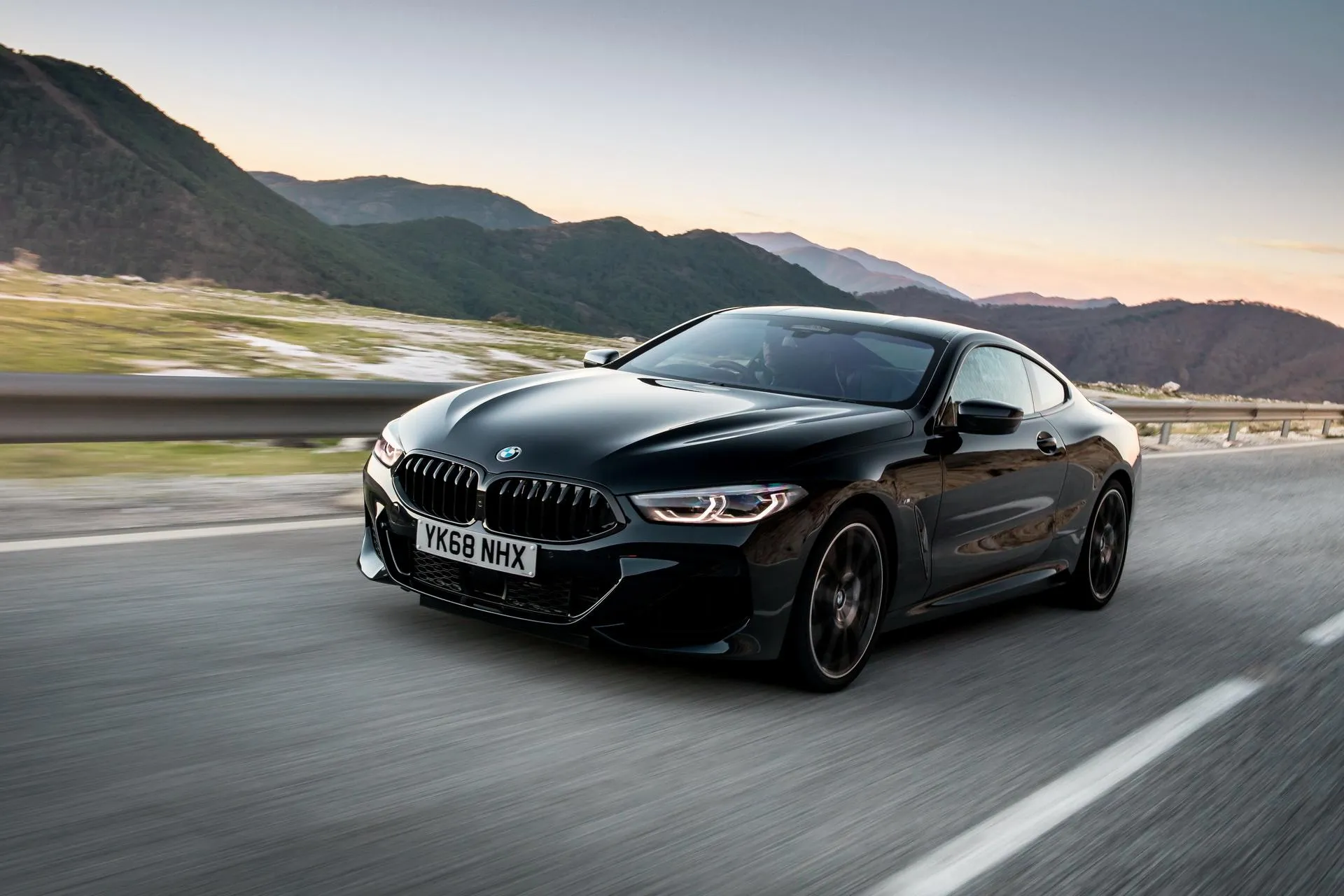 Bmw M Series Sports Car on Scenic Mountain Road Wallpaper