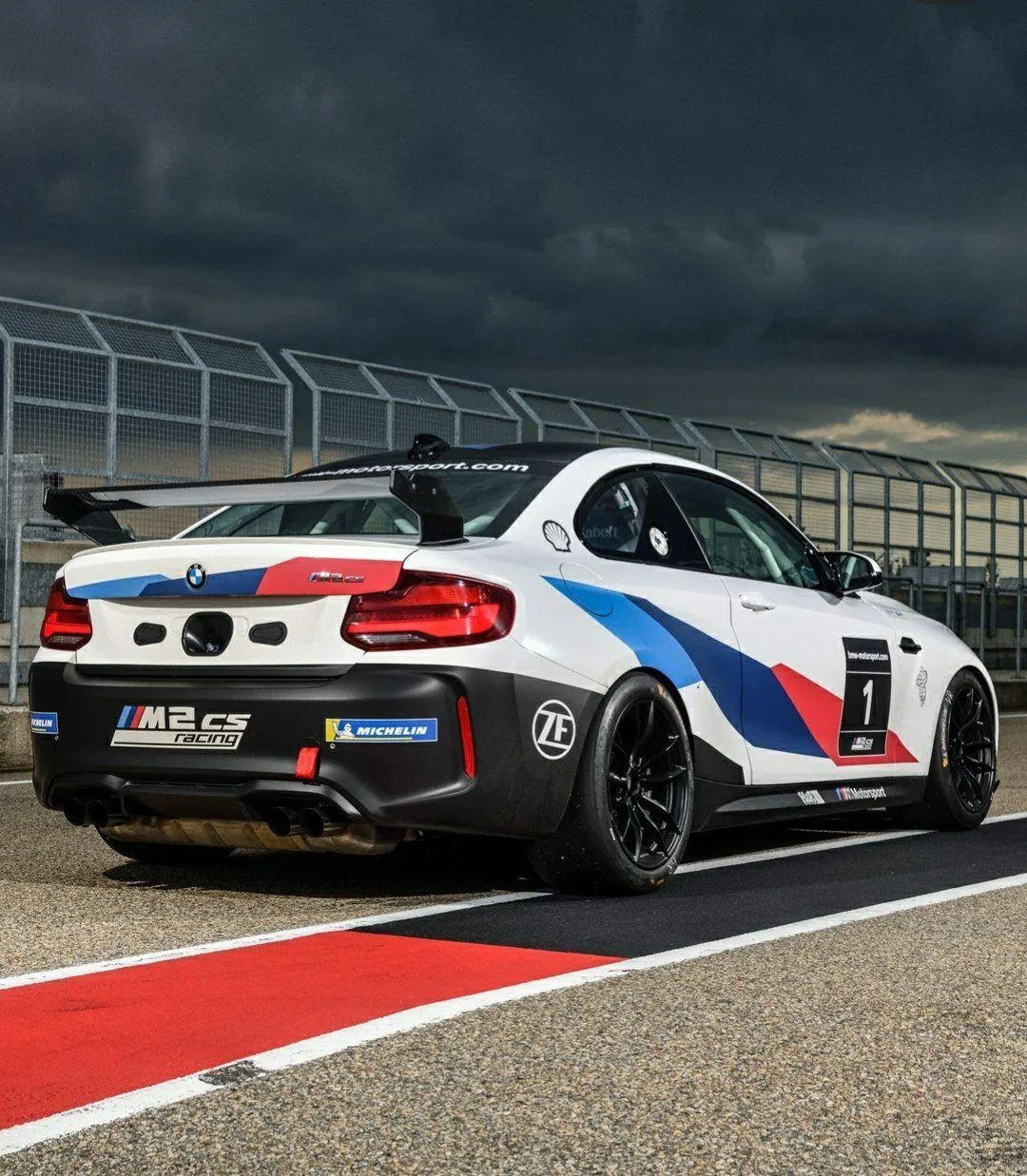 Bmw M2 Sports Car Drifting on a Racetrack During Sunset Light