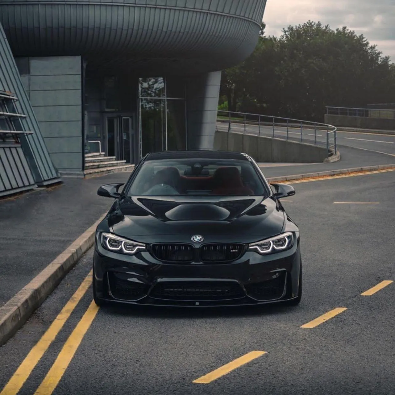 Bmw M4 Parked Near a Modern Structure on a Clean Street