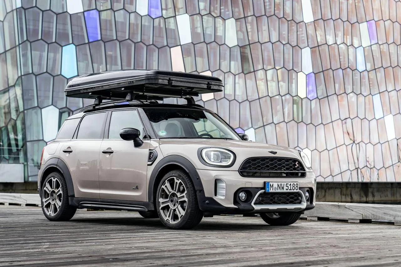 Bmw Mini Suv Parked Beside a Modern Glass Building