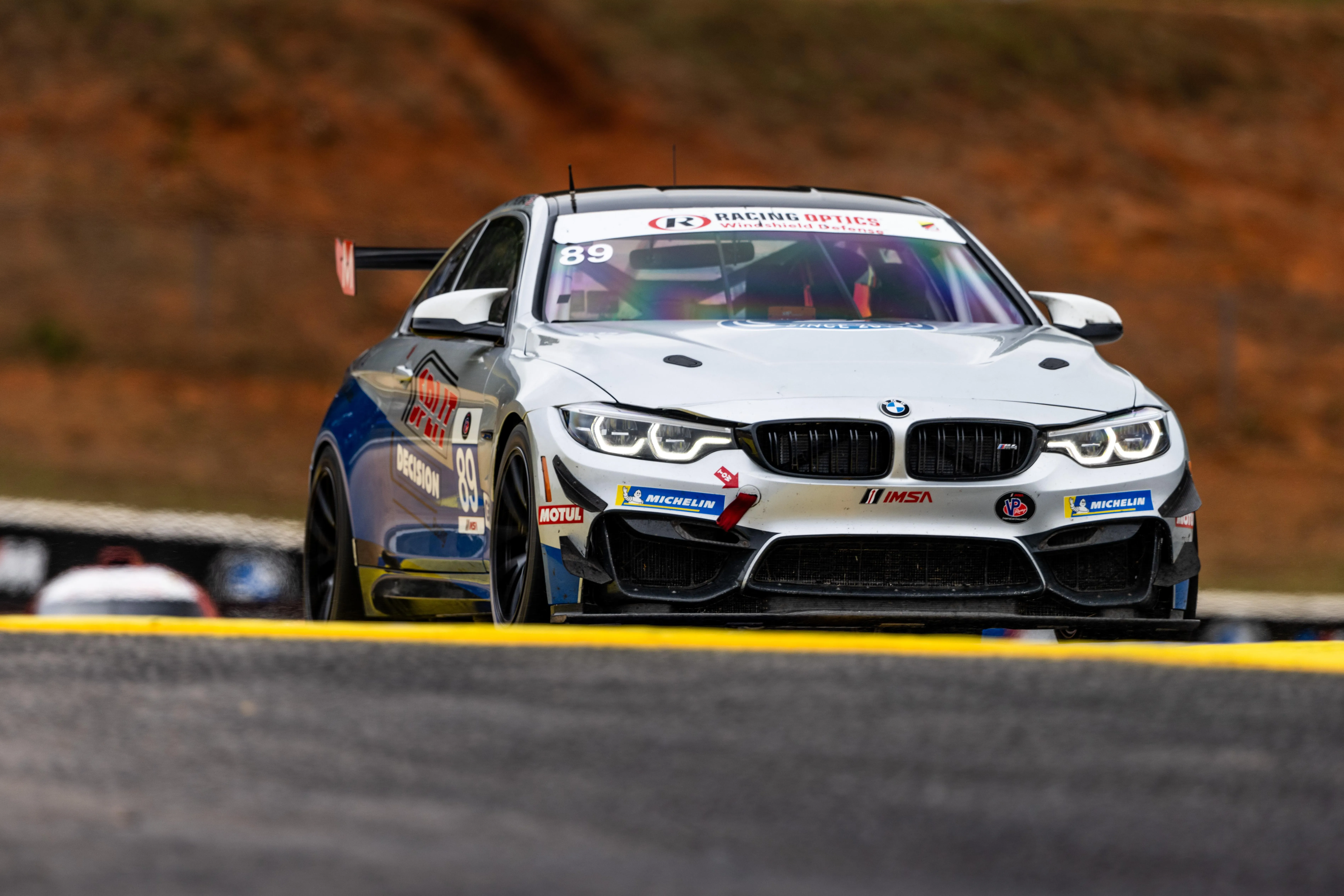 Bmw Motorsport Car Racing on Track with Blurred Background