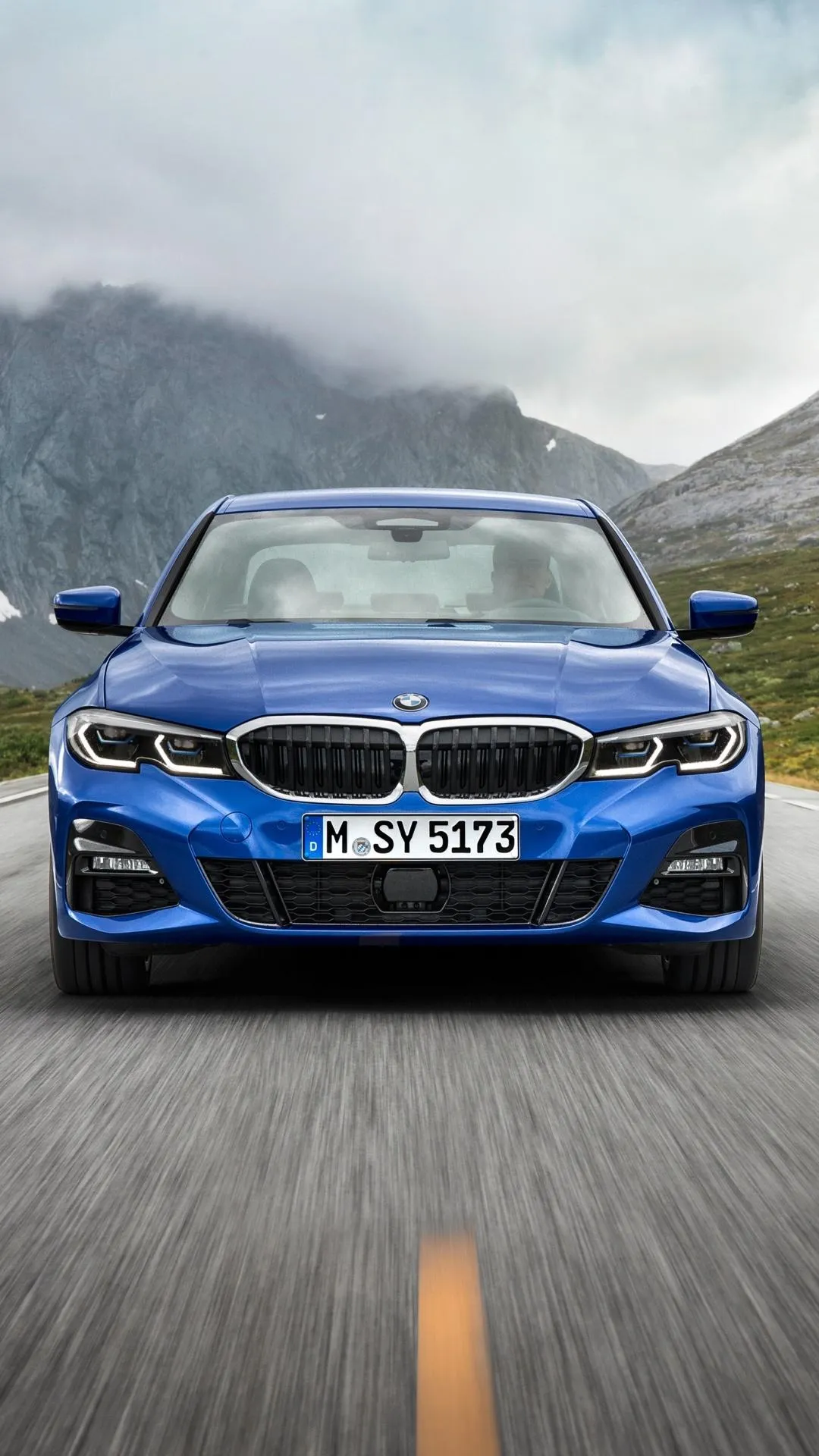 Bmw on an Open Road with Snowy Mountain Range Behind