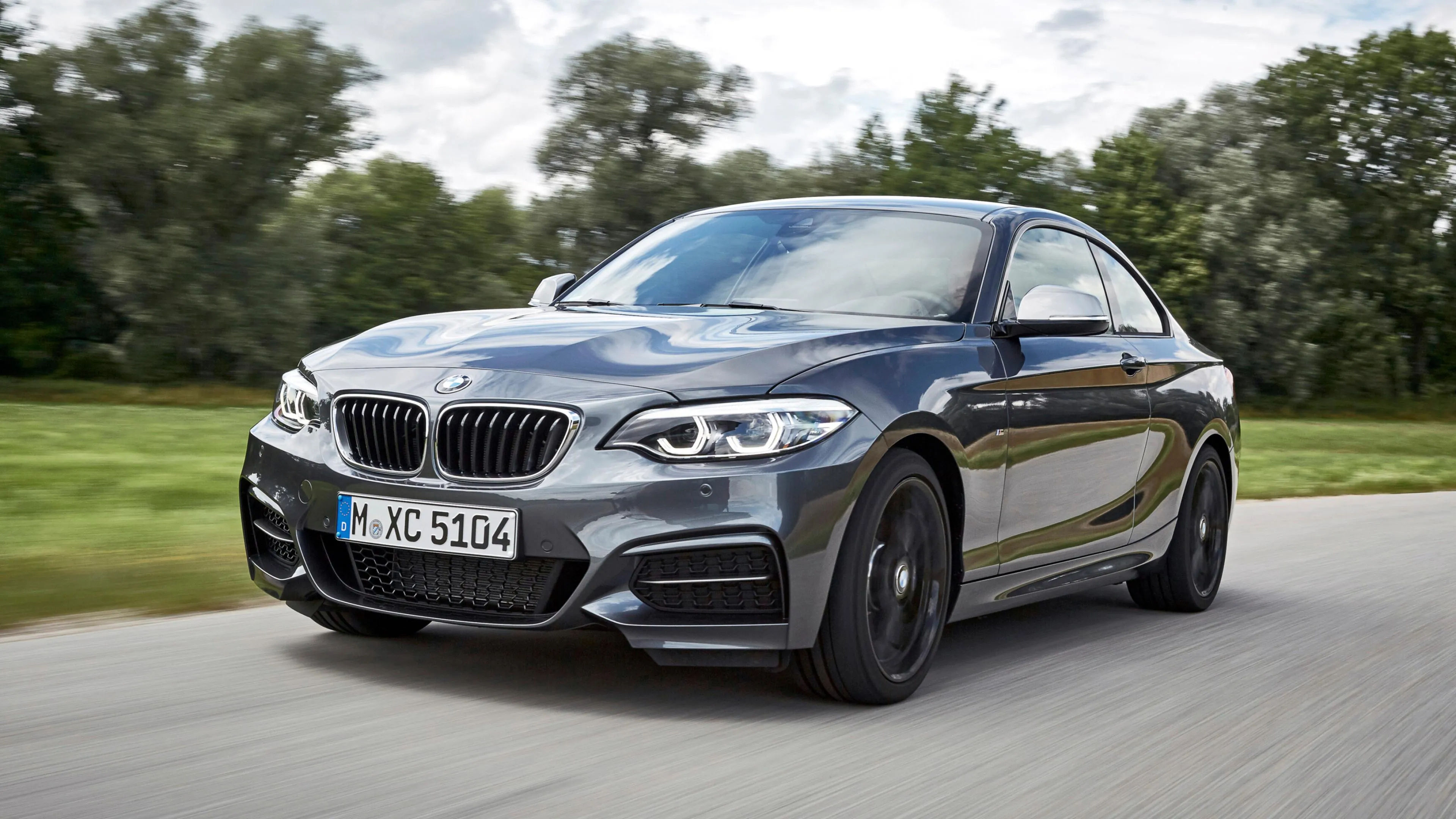 Bmw on Green Lawn with Elegant Natural Backdrop Wallpaper