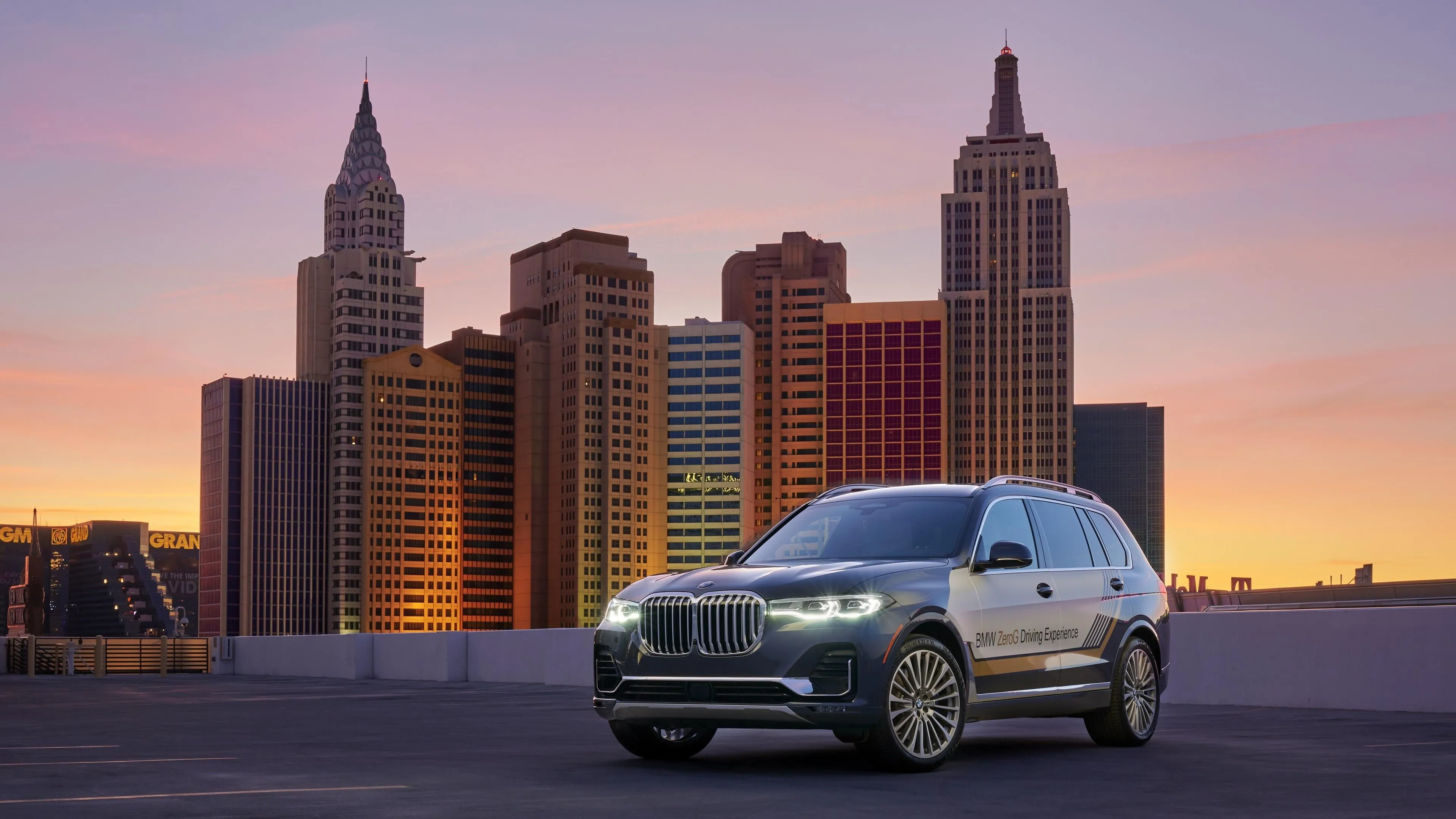 Bmw Parked at Sunset with City Skyline in the Background