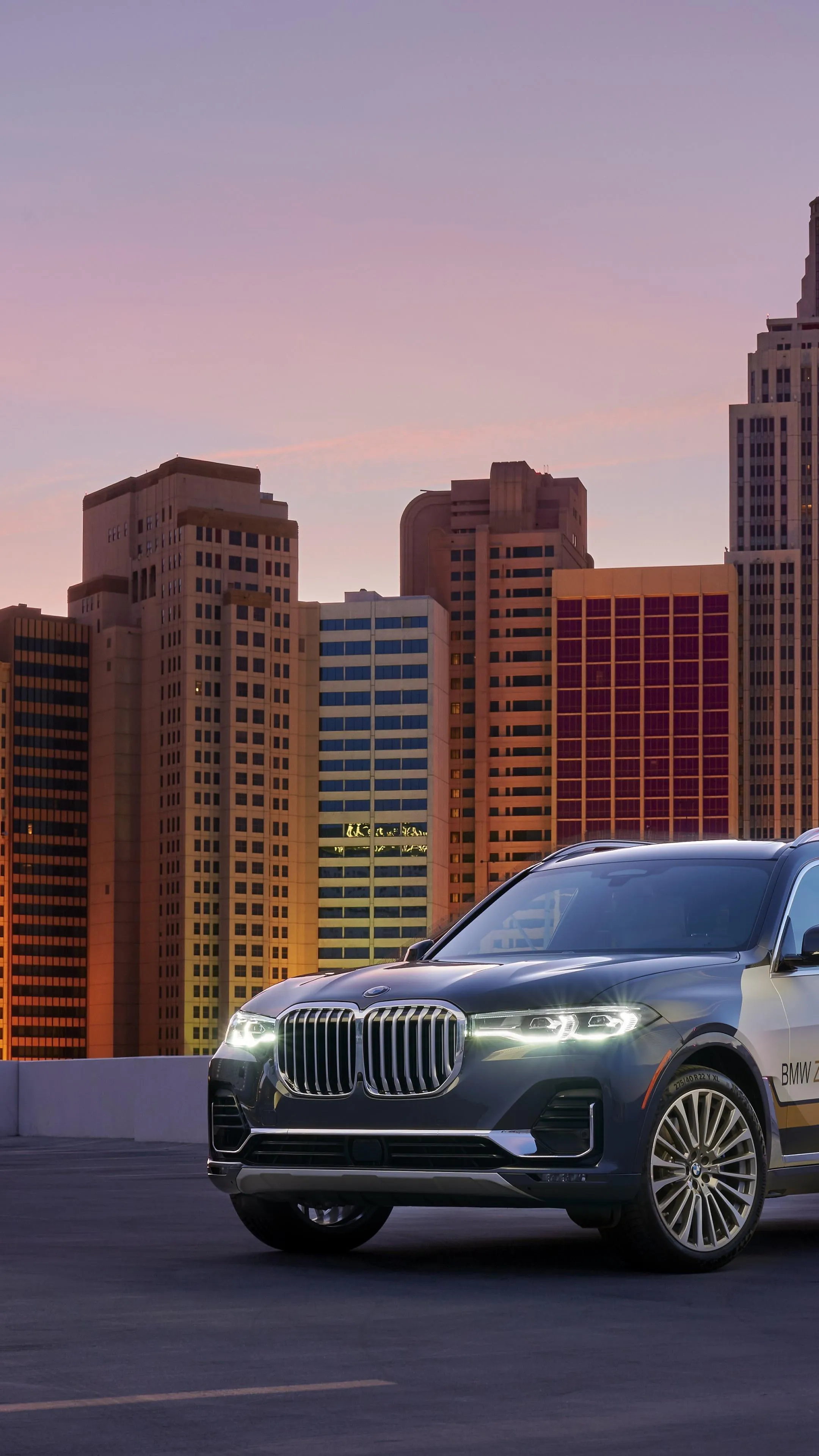 Bmw Parked at Sunset with City Towers in the Background