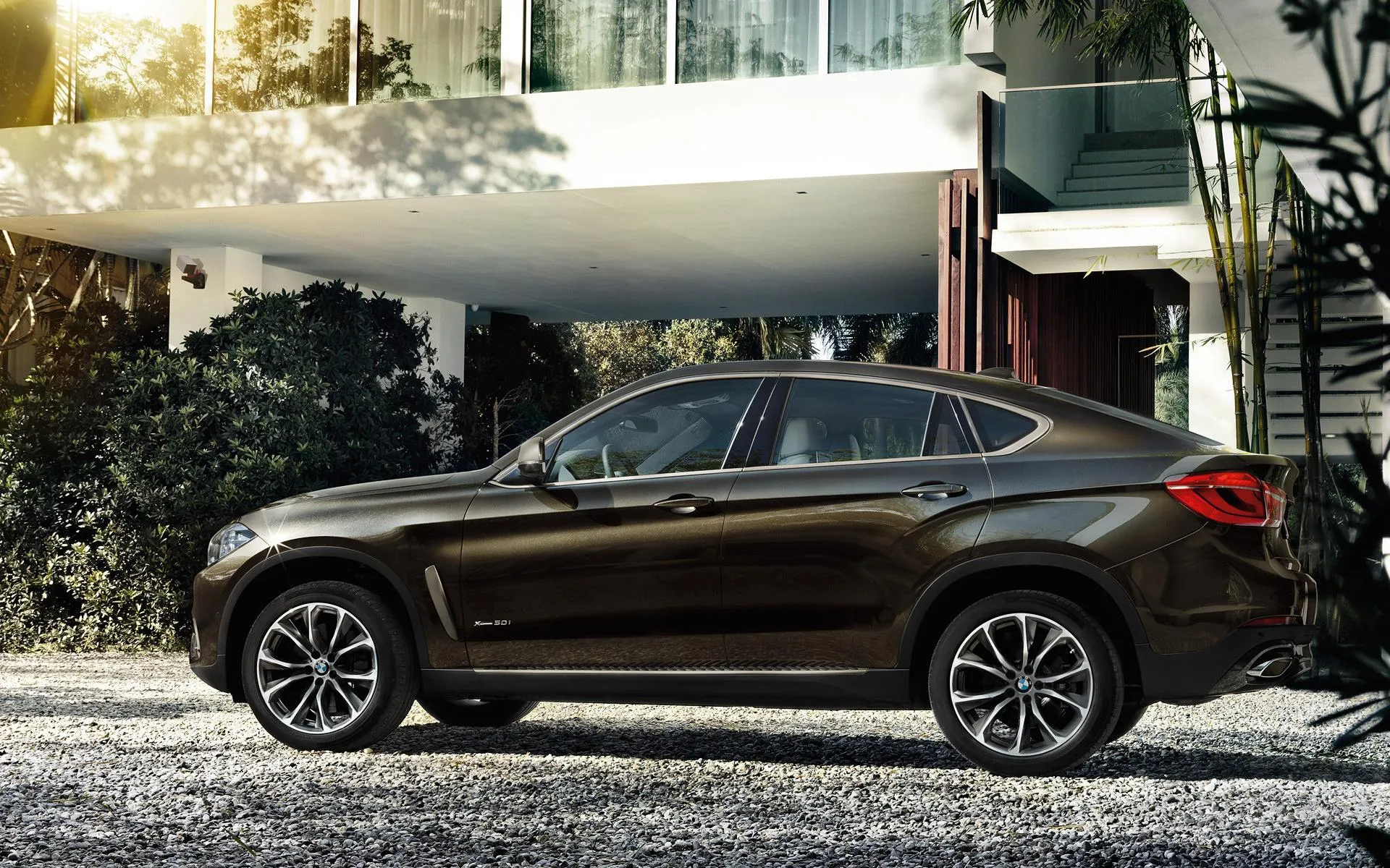 Bmw Parked Outside a Stylish Luxury House with Greenery
