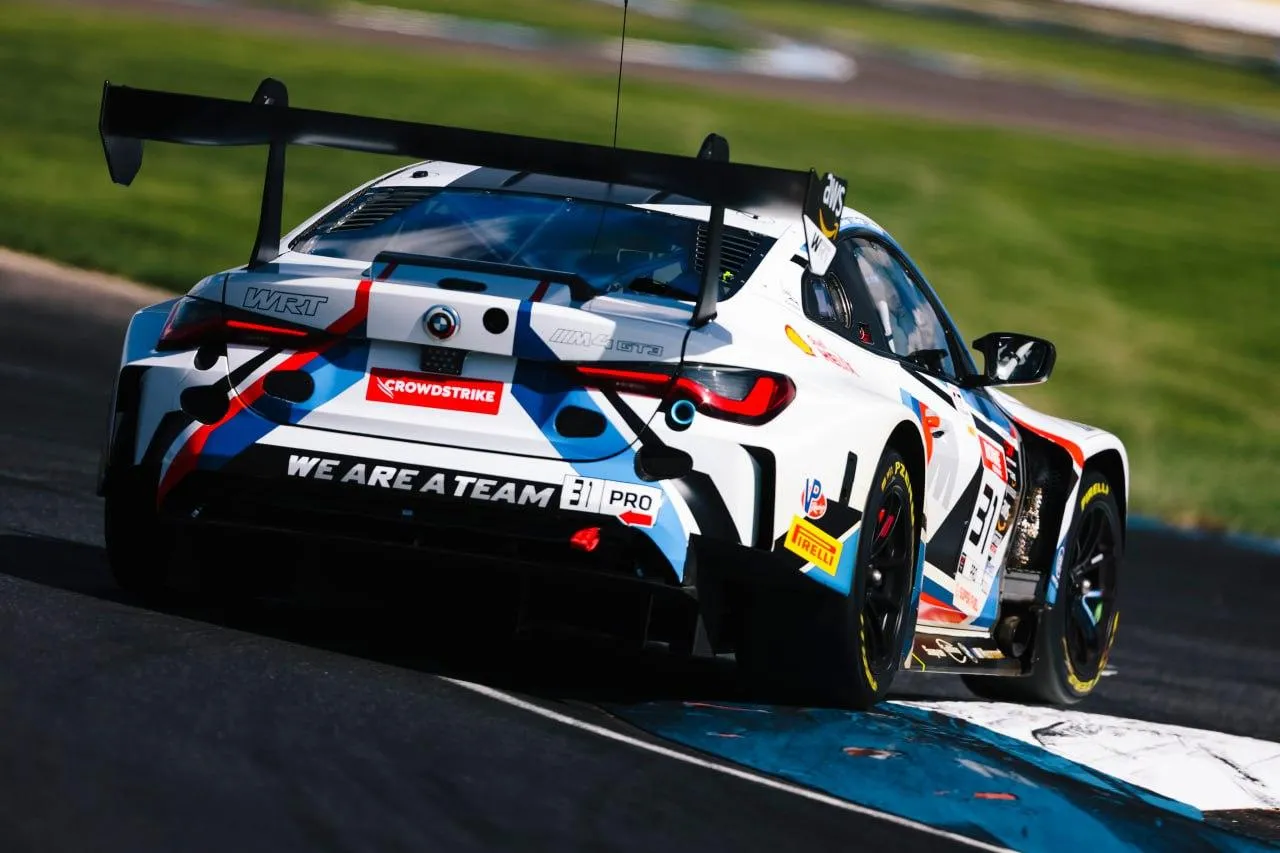 Bmw Race Car Driving on Track with Rear Spoiler Wallpaper
