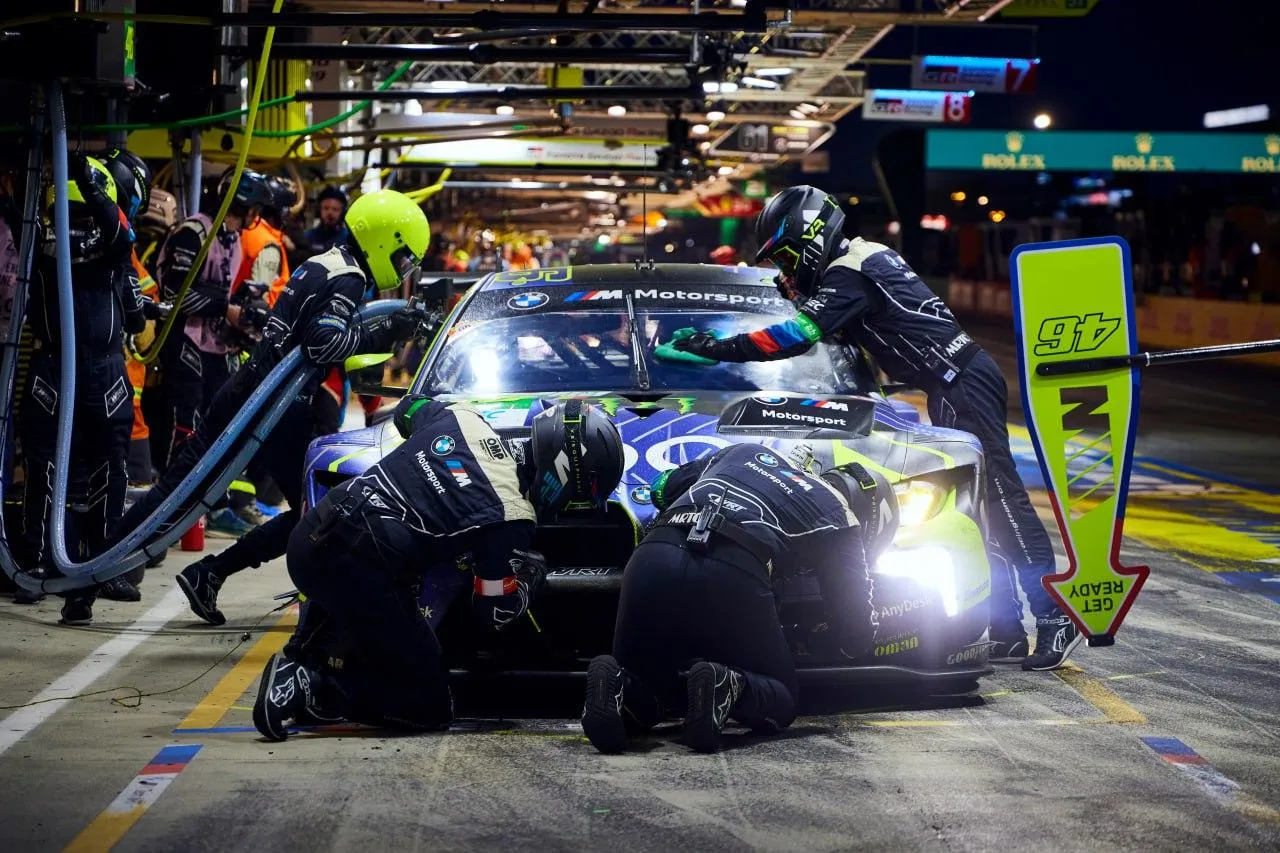 Bmw Race Car in Pit Stop with Mechanics Working Fast