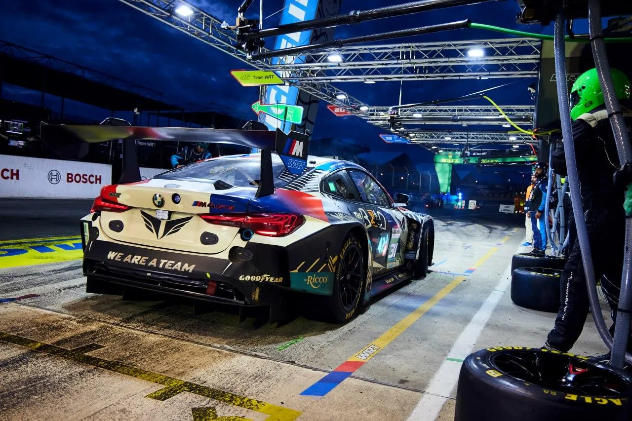 Bmw Race Car in Pit with Crew Working in a Professional Garage