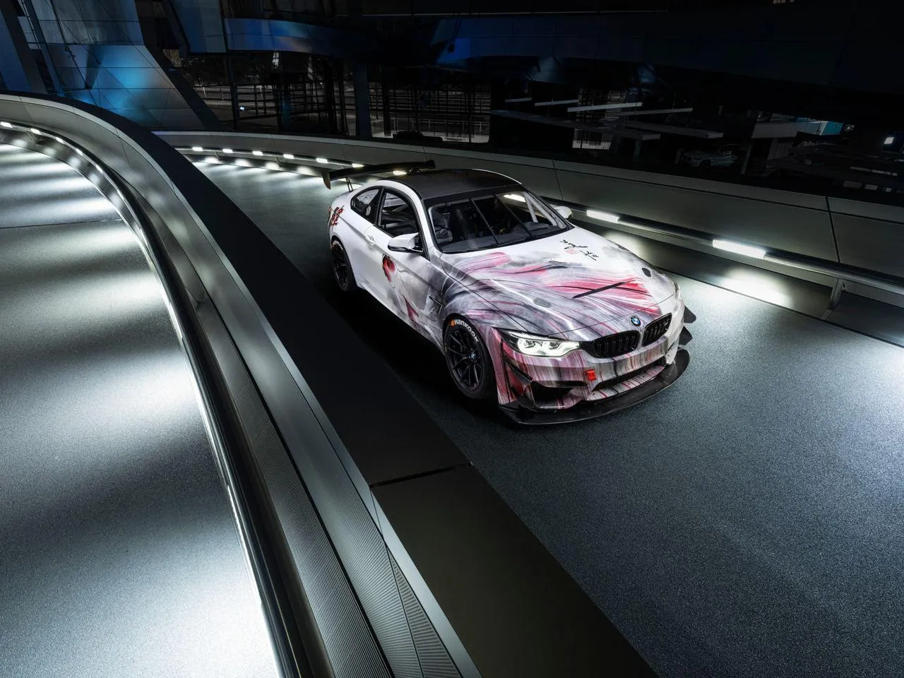Bmw Race Car on a Lit Track with Dramatic Lighting