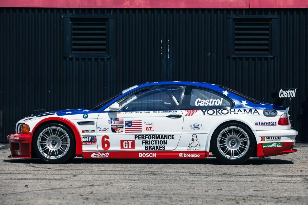 Bmw Race Car on the Track with Bold Red and White Livery