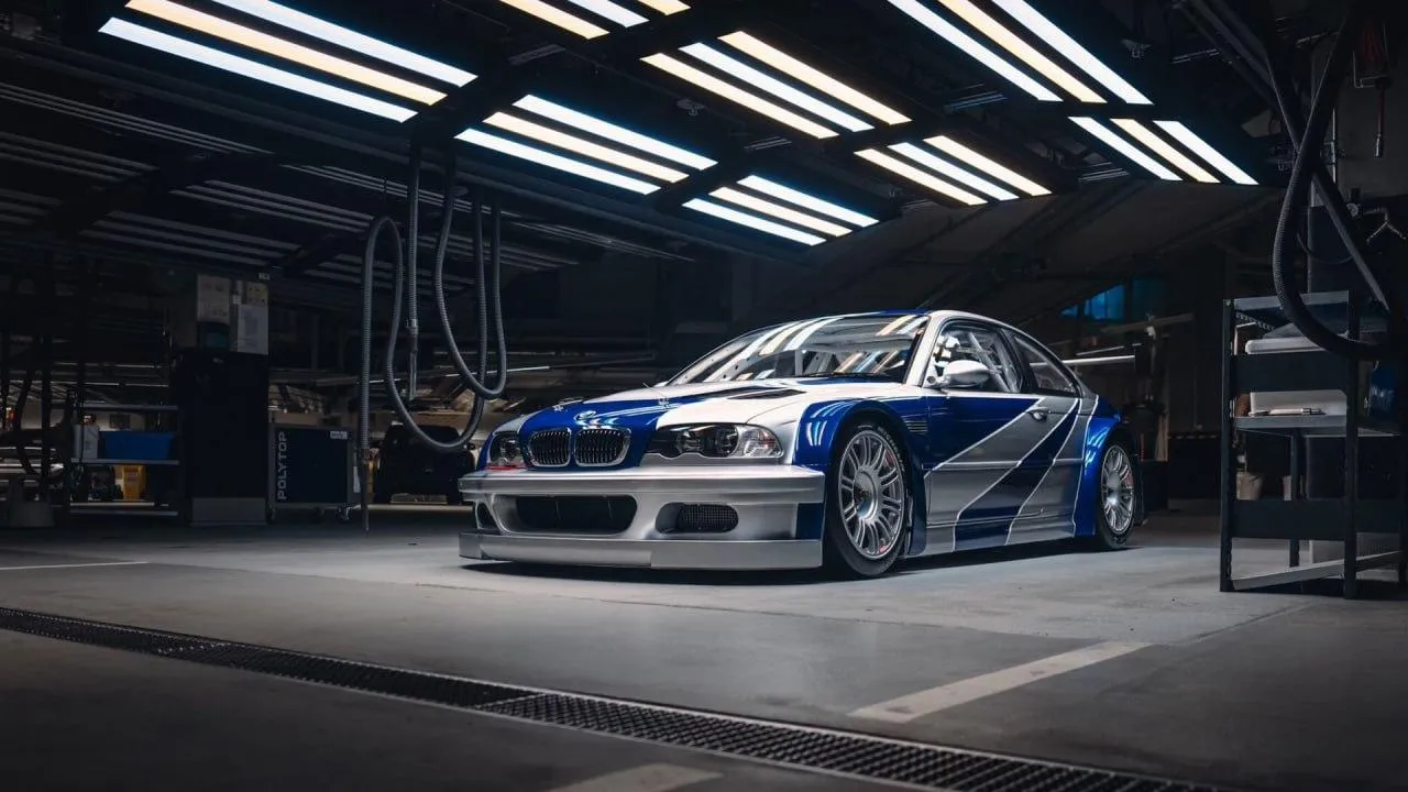 Bmw Race Car Sitting in a Dimly Lit Garage Before Race