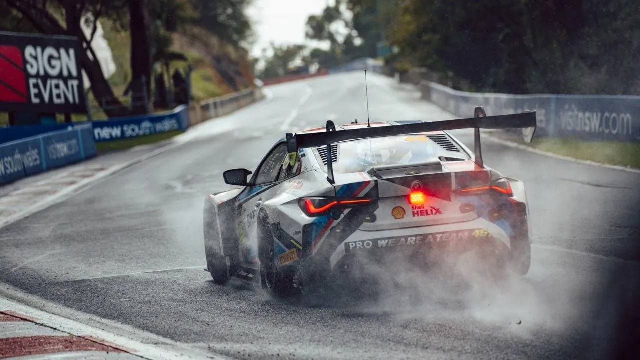 Bmw Race Car Sliding on Wet Track During Rainy Weather