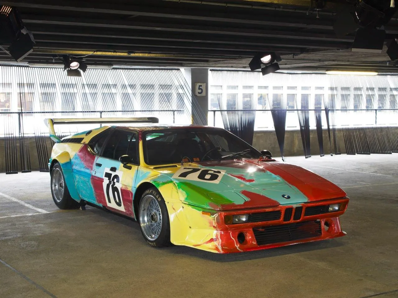 Bmw Race Car with Bold Colors and Pit Stop Environment