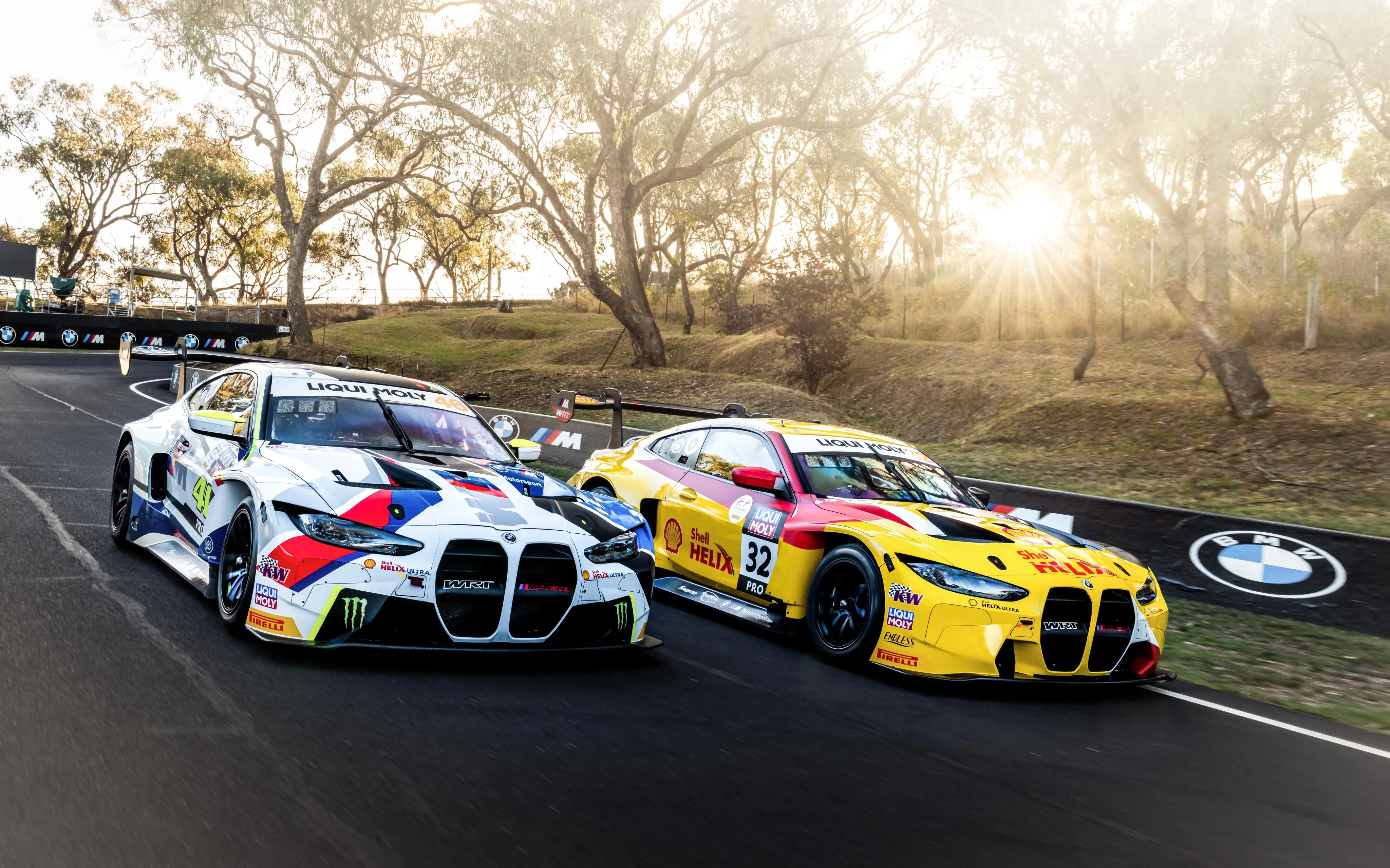 Bmw Race Cars Competing on Track During a Sunny Afternoon