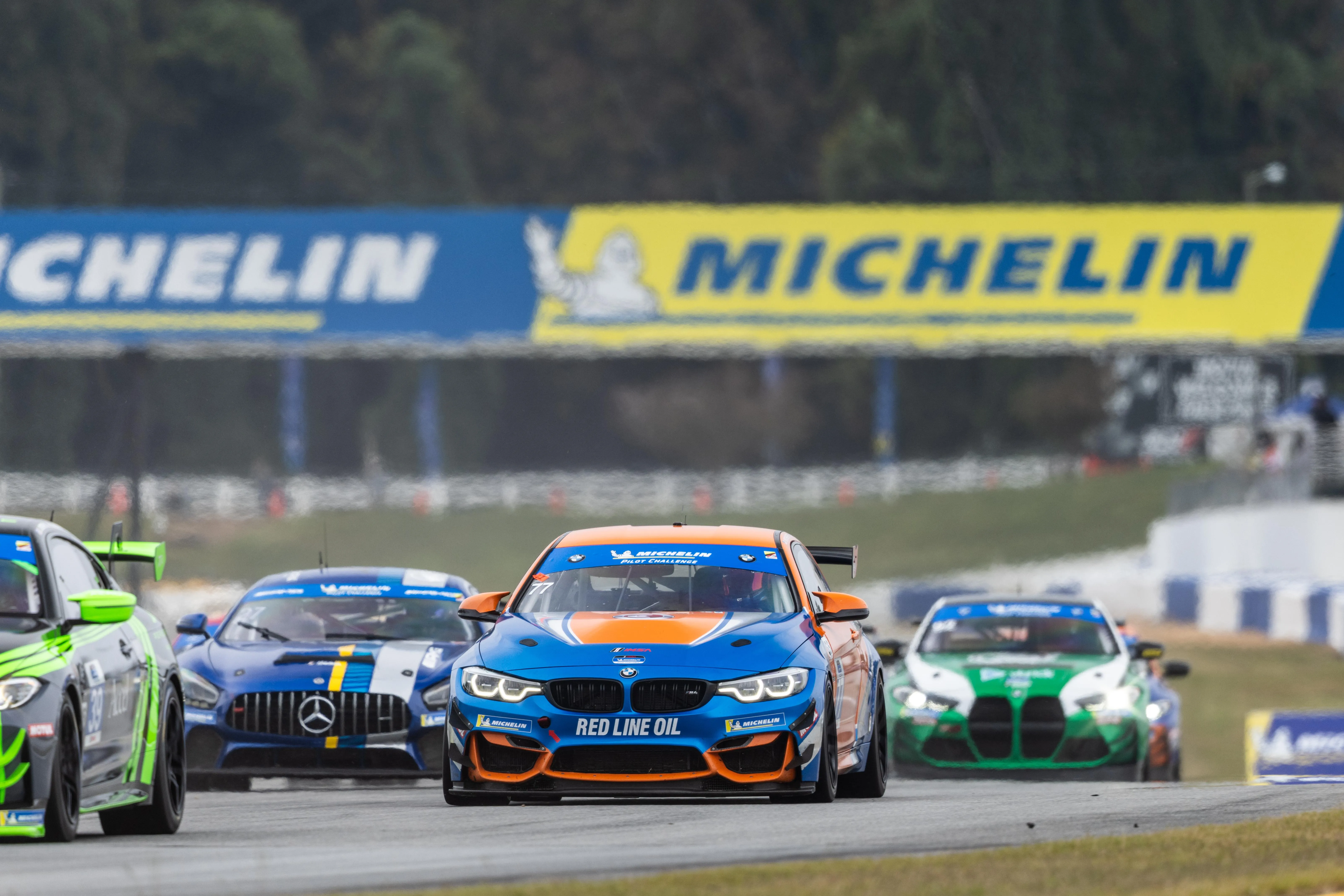 Bmw Race Cars Competing on Track with Michelin Banner