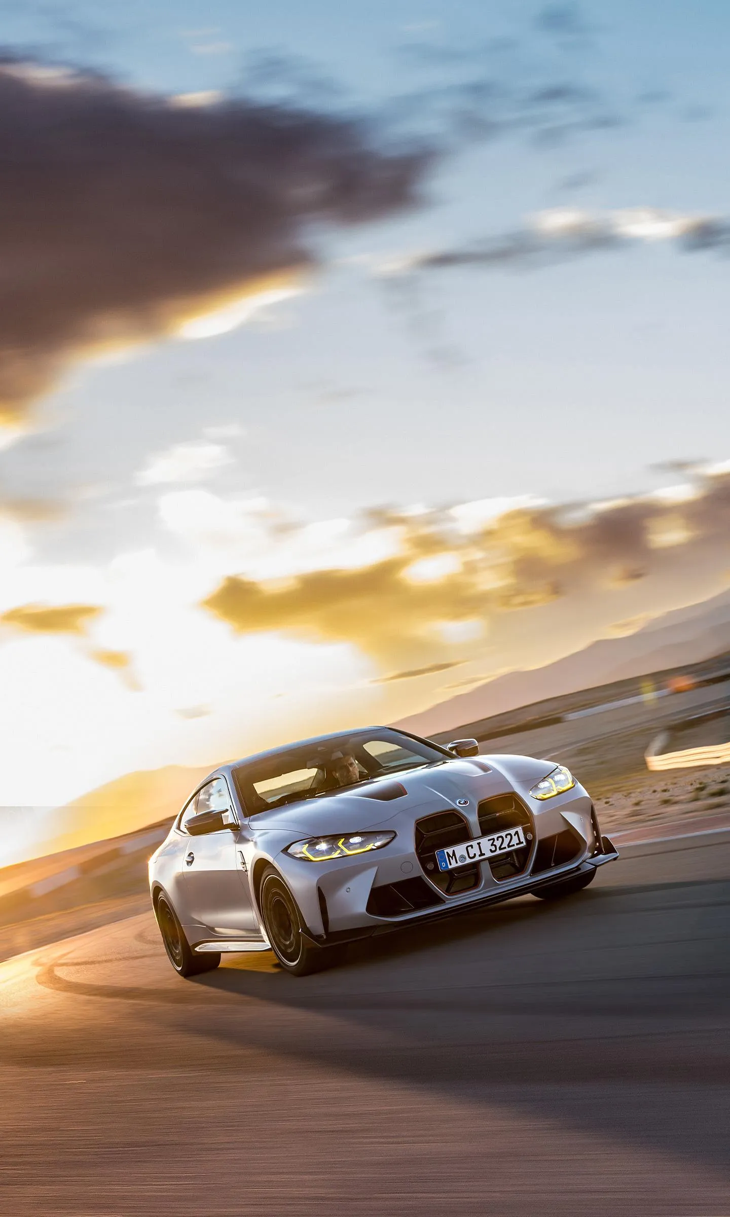 Bmw Race Cars Driving at Sunset on an Open Highway
