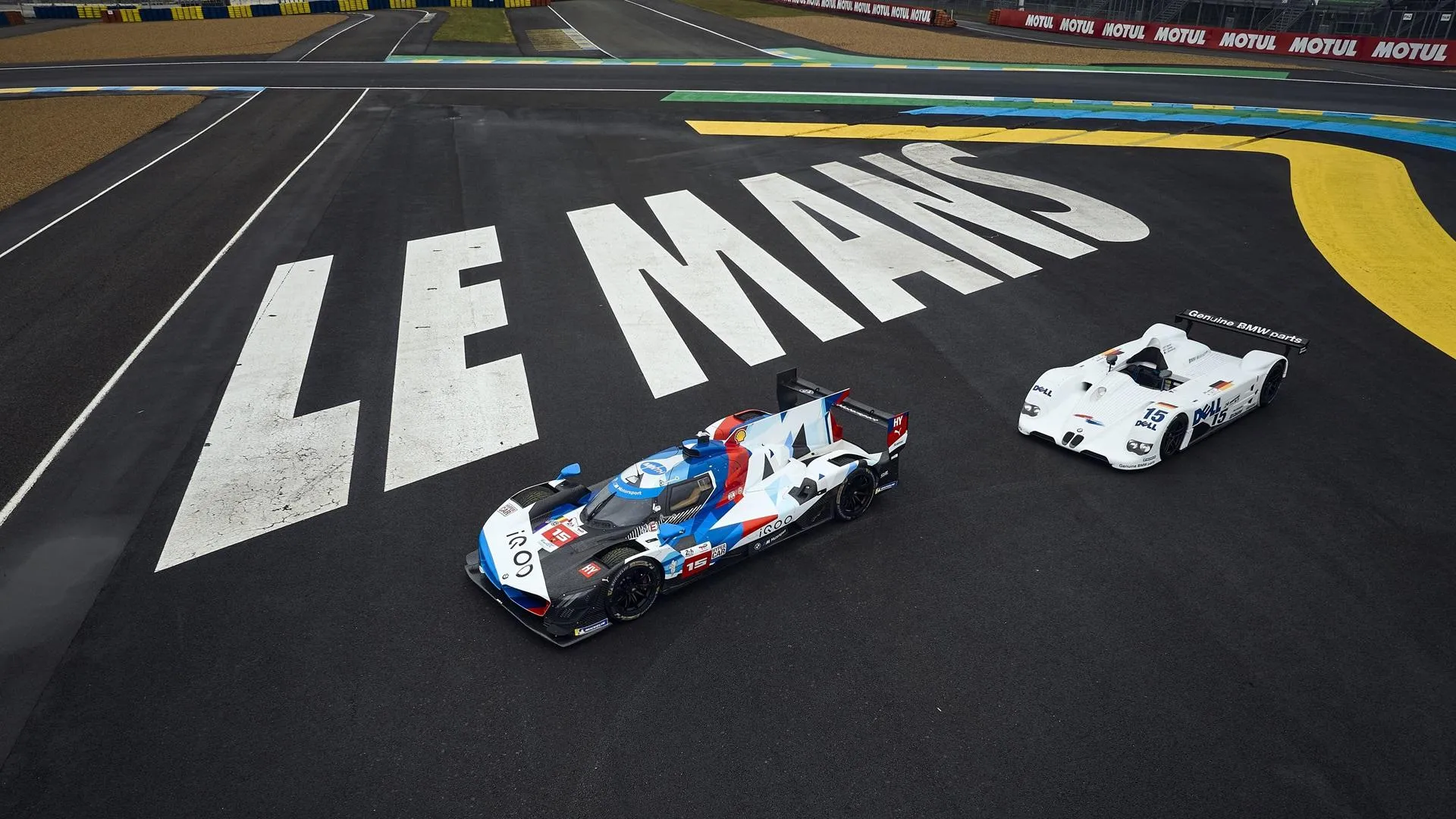 Bmw Race Cars Speeding on the Le Mans Track During Sunset