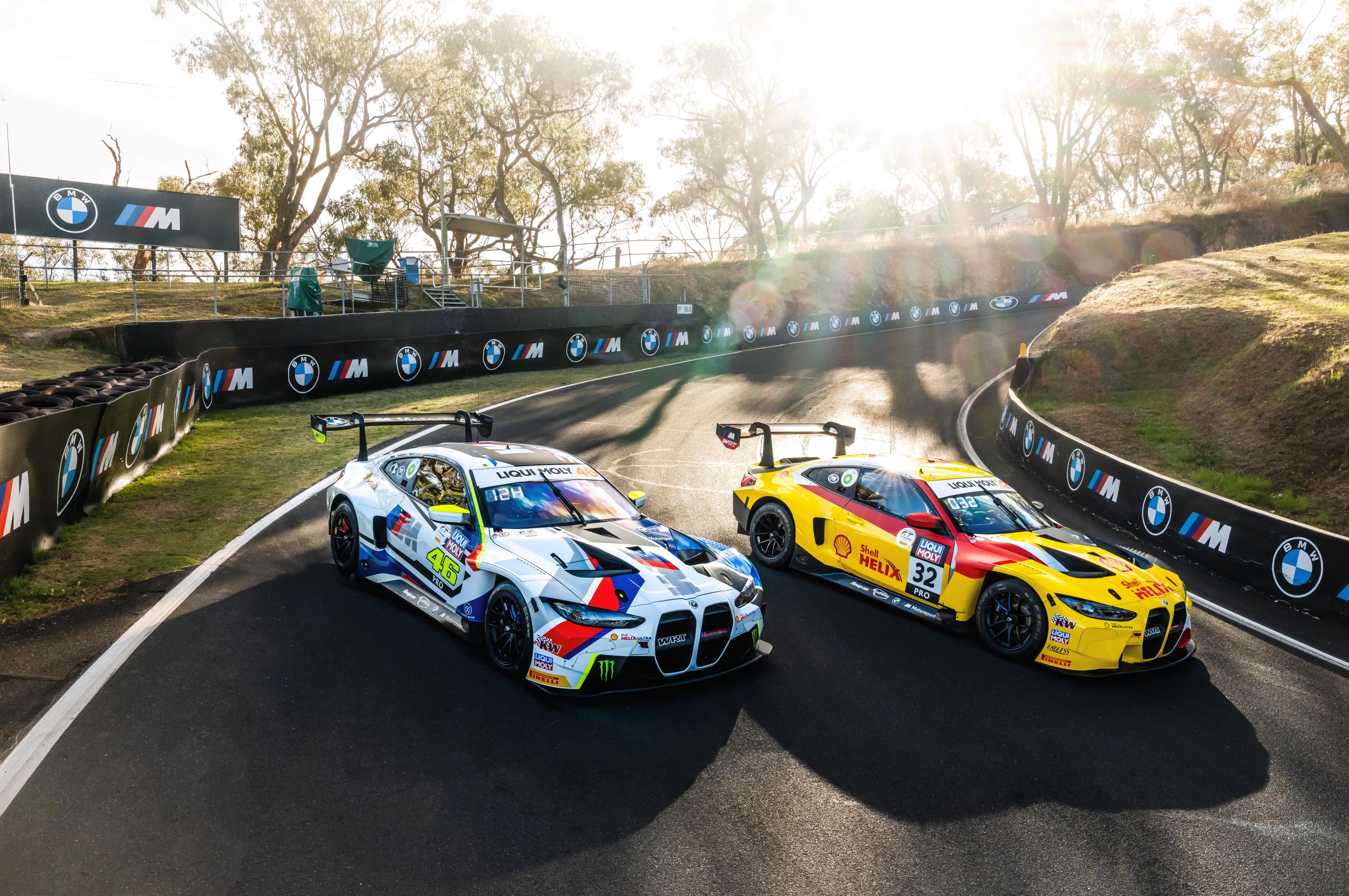 Bmw Race Cars Taking a Turn on a Sunlit Racing Track