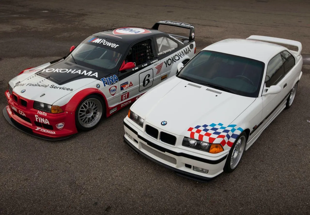 Bmw Racing Car on Track with Dynamic Movement Wallpaper