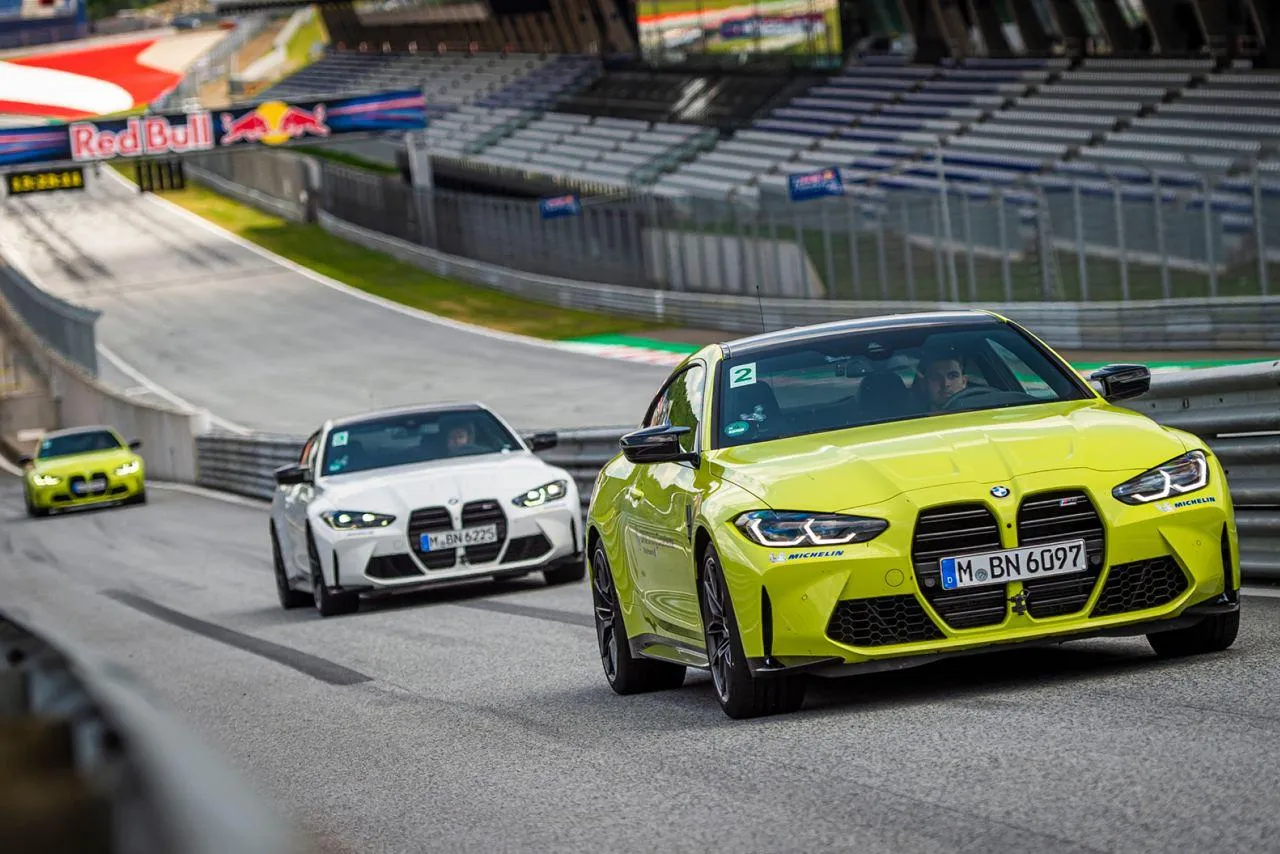 Bmw Racing Cars Speeding Through a Track with Motion Blur