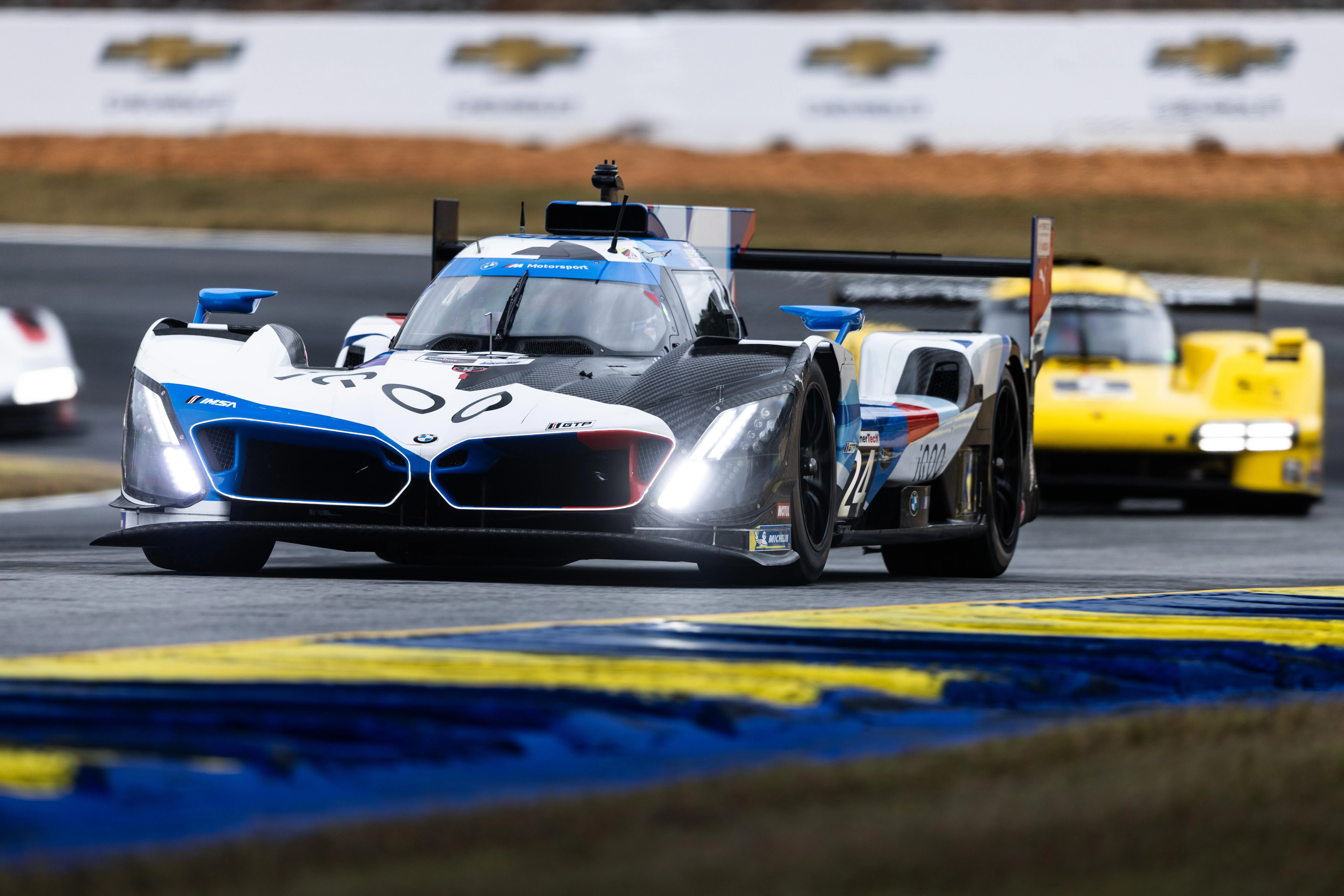 Bmw Racing in a Motorsport Event with Competitors on Track