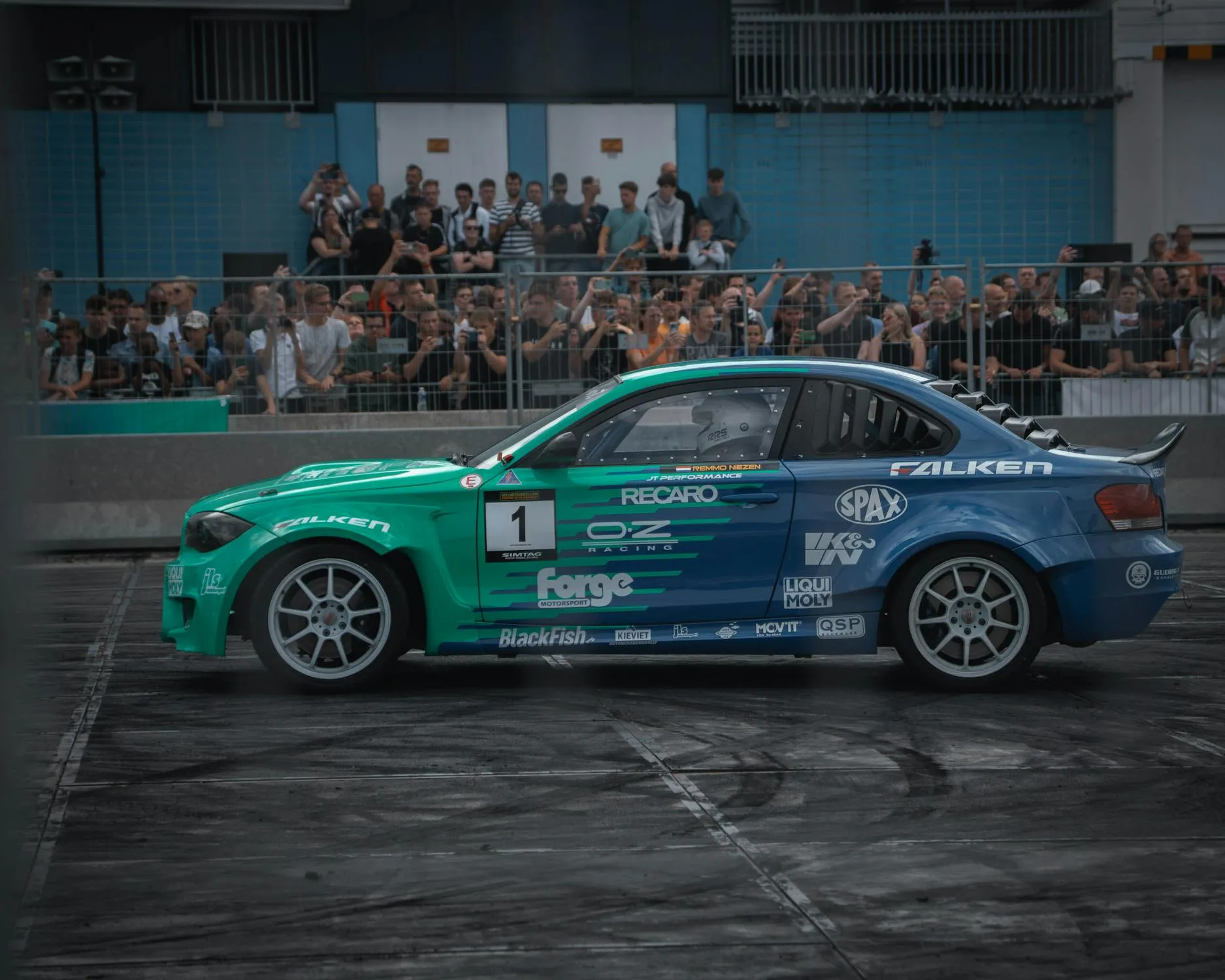 Bmw Racing Sedan in Action at a Car Event with Fans